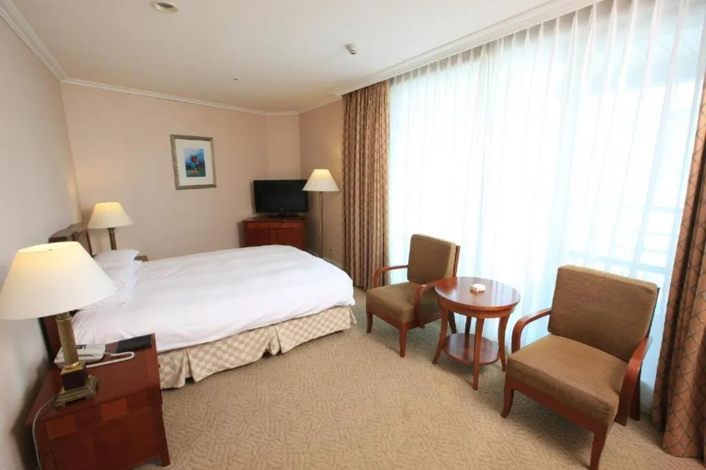 Bed in High1 Palace Hotel and CC