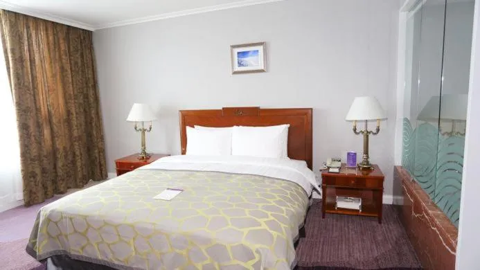 Bed in High1 Palace Hotel and CC