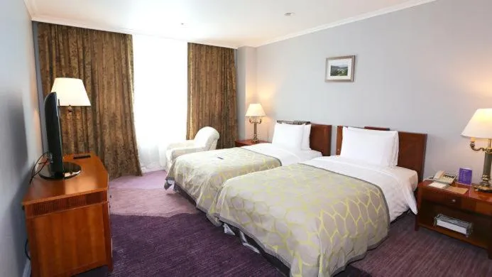 Bed in High1 Palace Hotel and CC