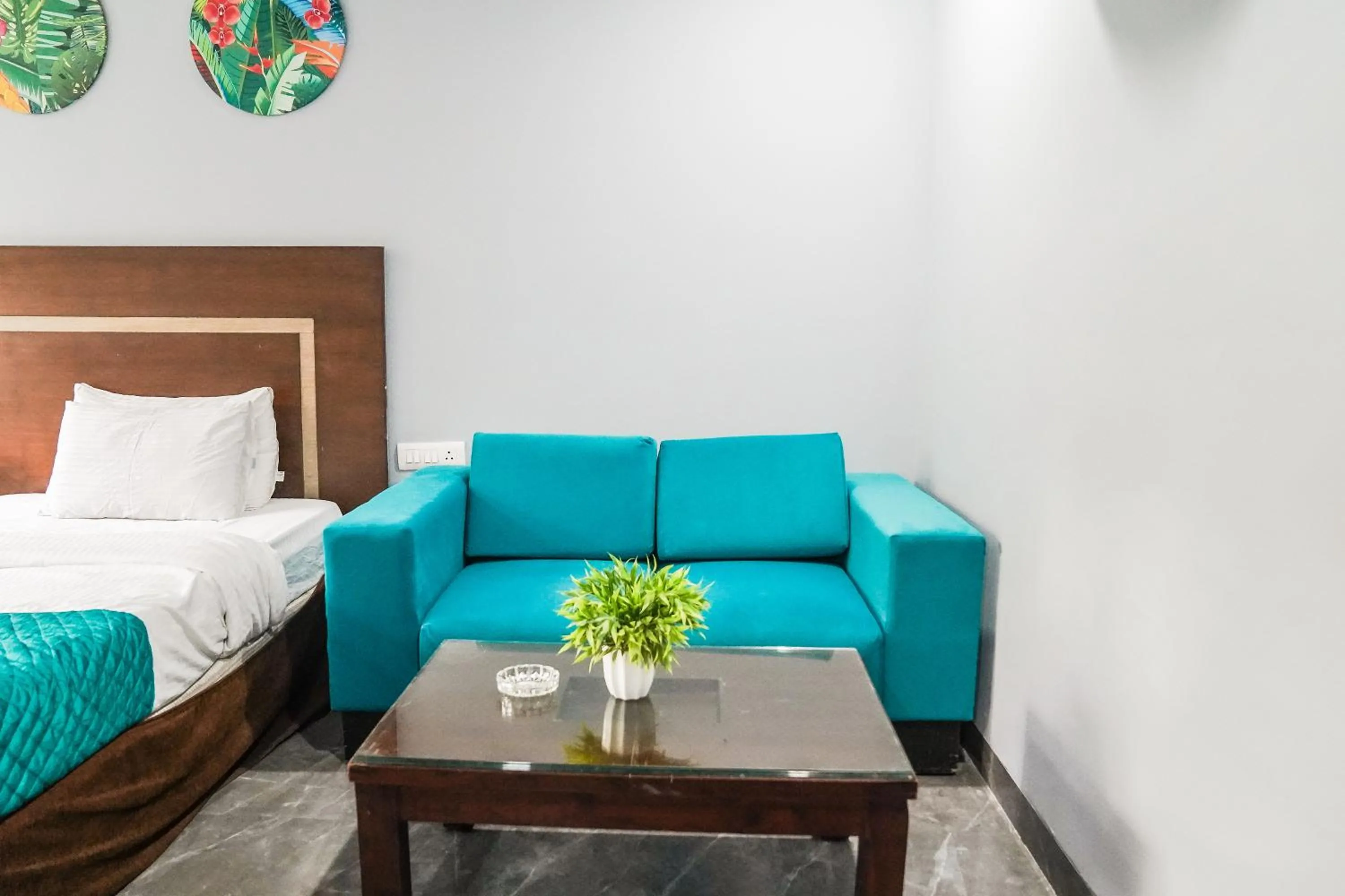 Seating area, Bed in Asian Suites IFFCO Metro Station Gurugram