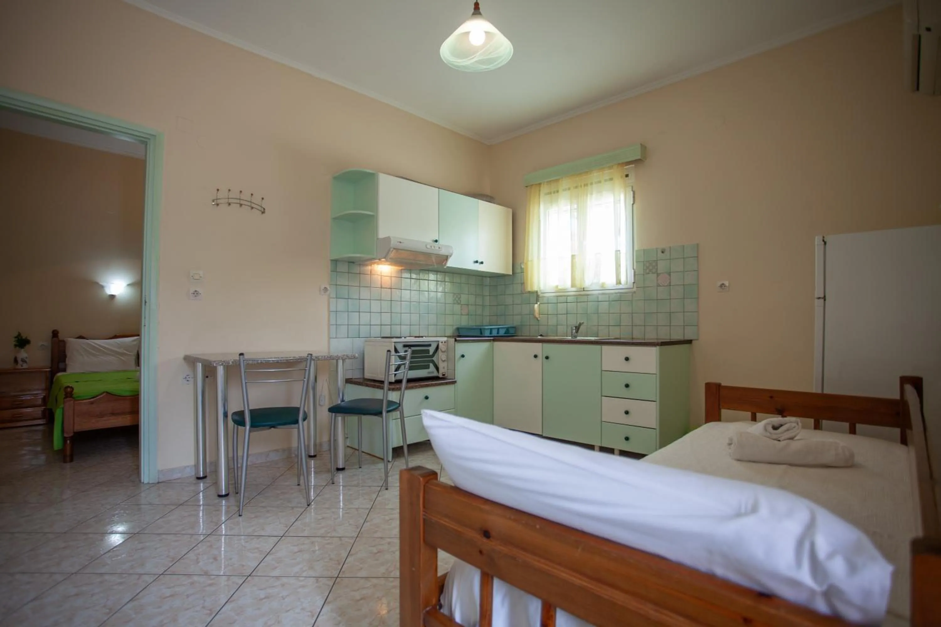 Kitchen or kitchenette, Bed in Eliza Apartments