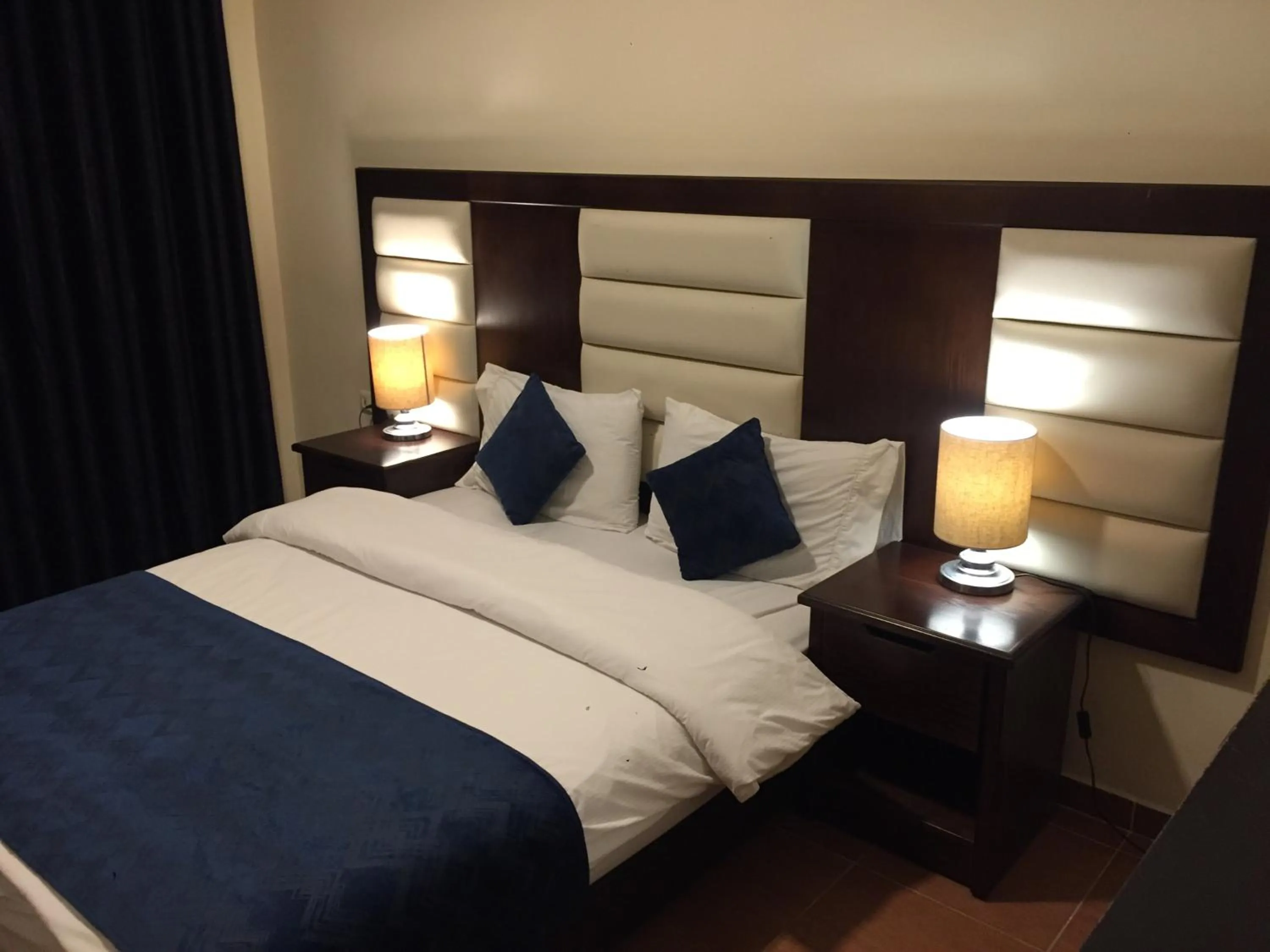 Bed in Uptown Hotel Apartment