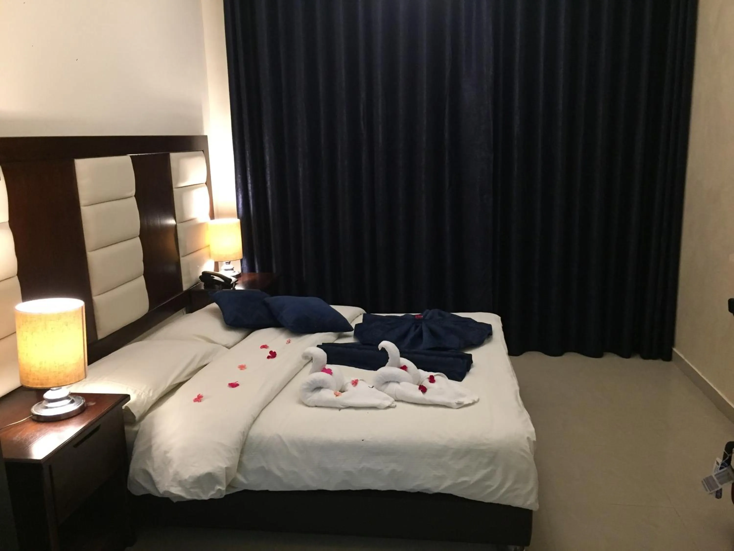 Bed in Uptown Hotel Apartment