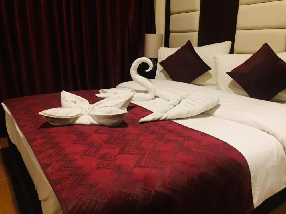 Bed in Uptown Hotel Apartment