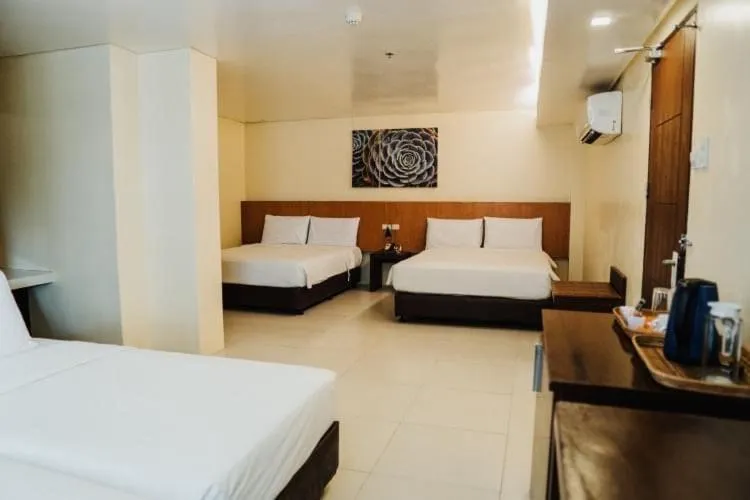Bed in Ocean Suites Bohol Boutique Hotel