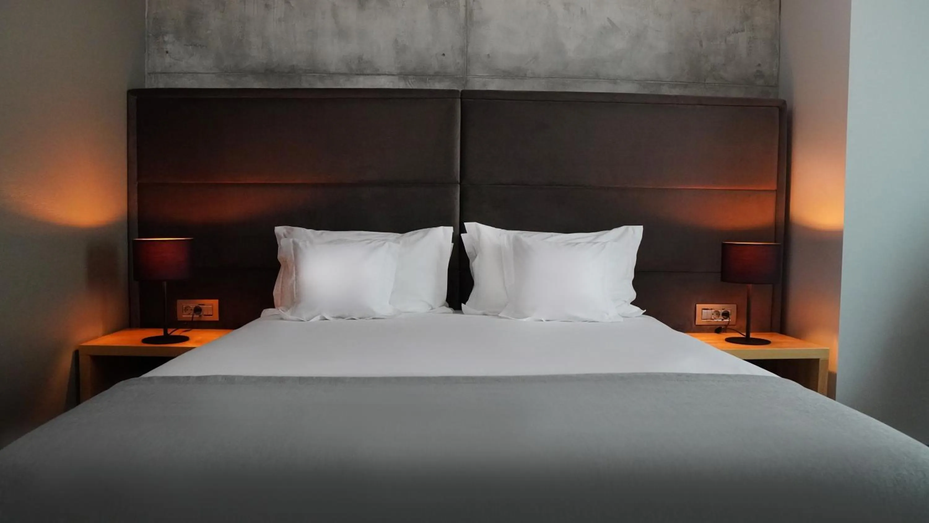 Bed in Aniroc Signature Hotel