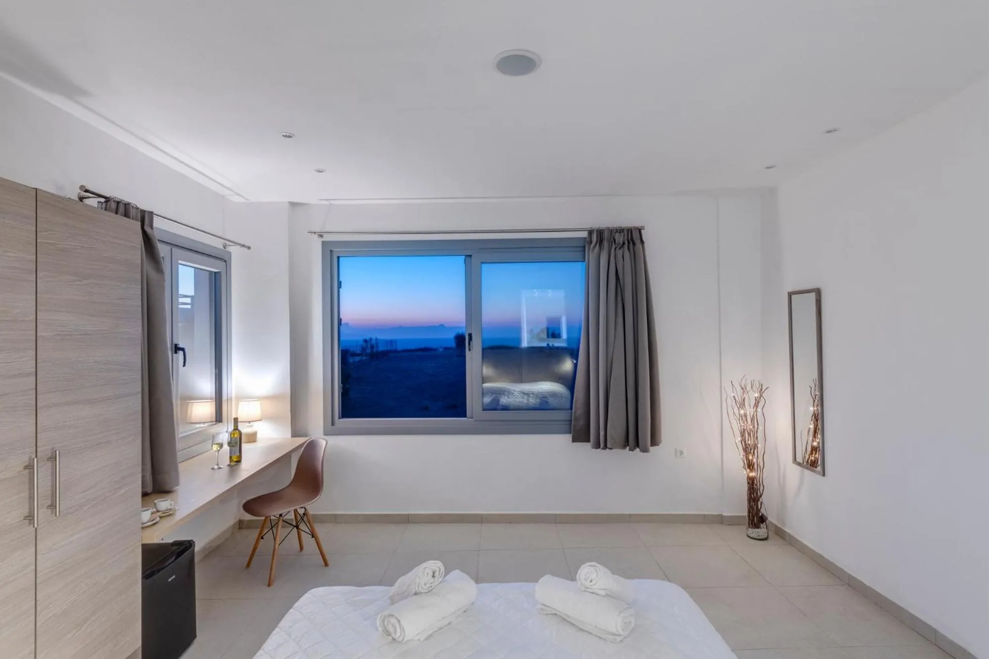 Bed in Chrysonisos Suites with Sunset & Seaviews near Kini