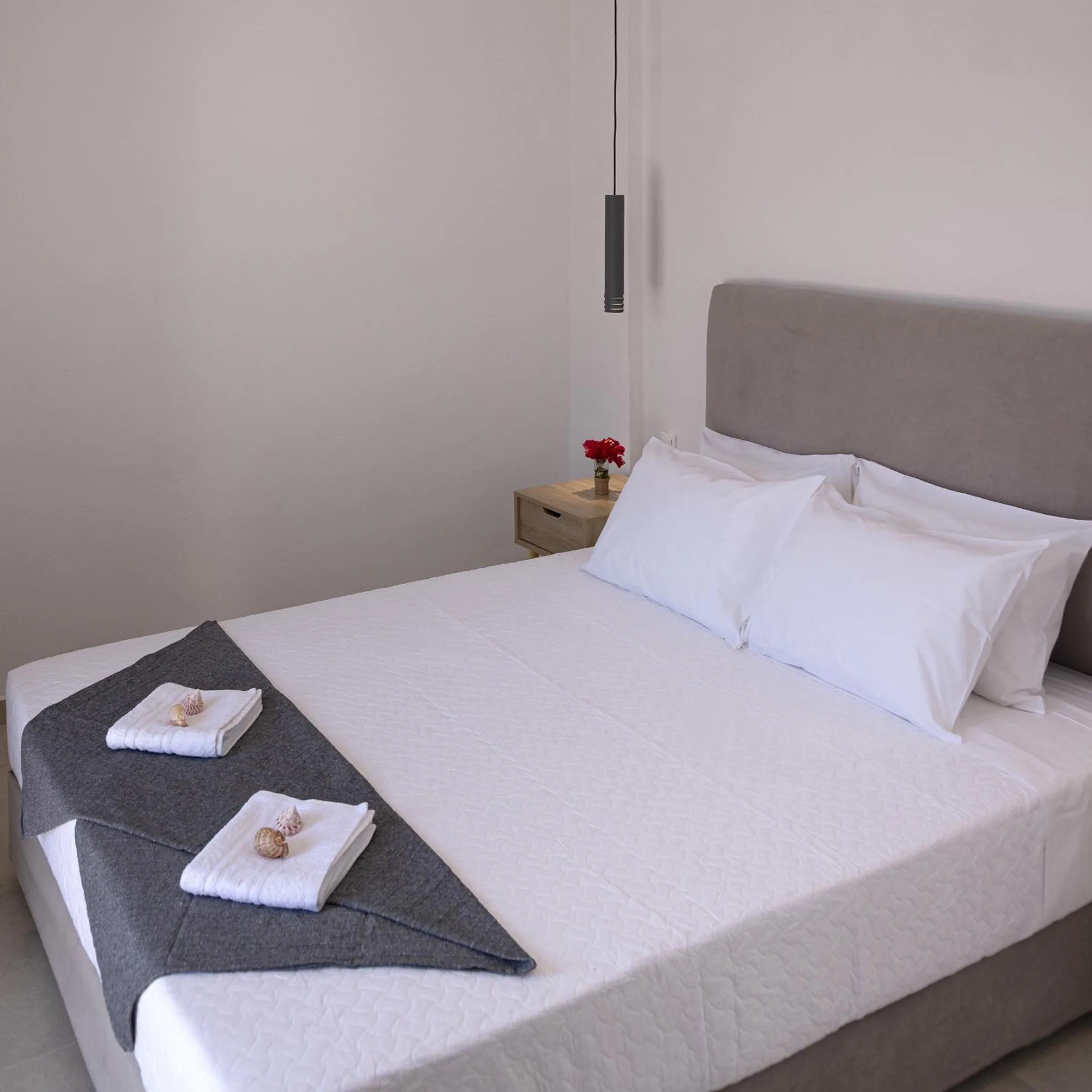 Bed in Chrysonisos Suites with Sunset & Seaviews near Kini