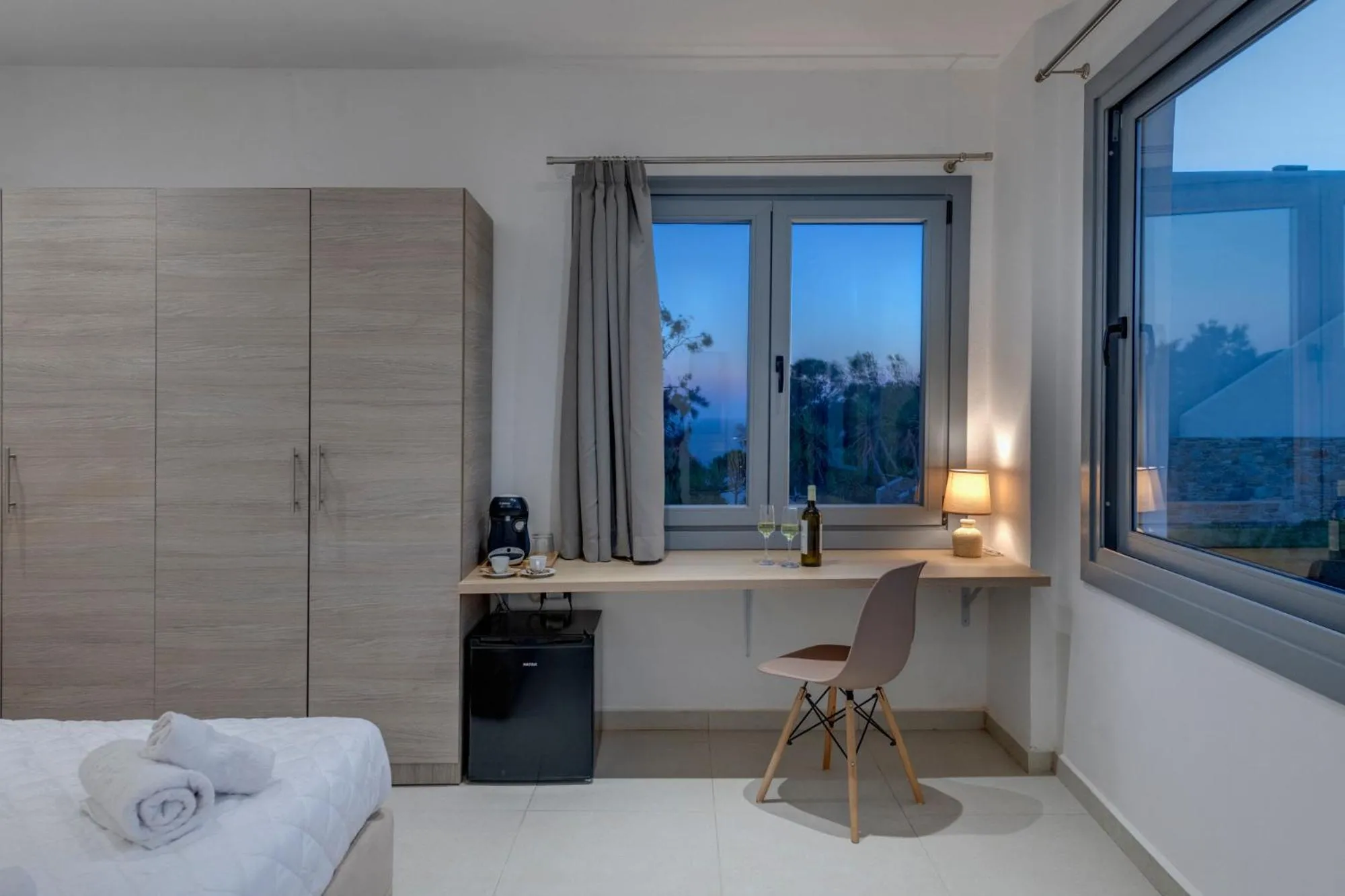 Bed in Chrysonisos Suites with Sunset & Seaviews near Kini
