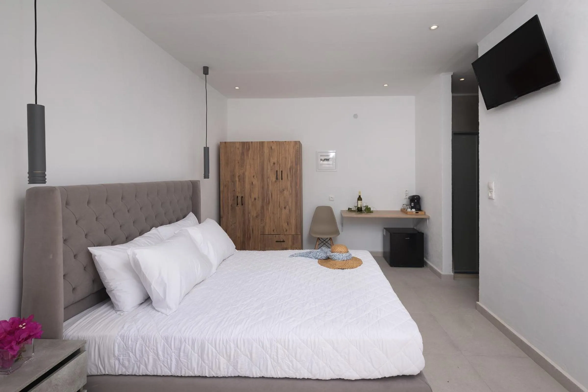 Bed in Chrysonisos Suites with Sunset & Seaviews near Kini