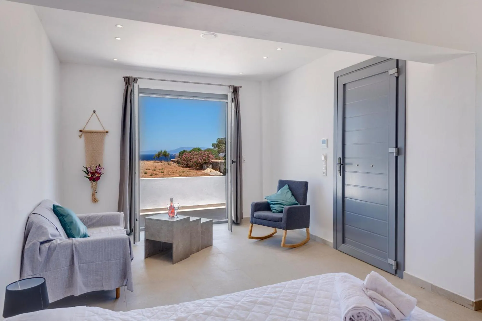 Bed in Chrysonisos Suites with Sunset & Seaviews near Kini