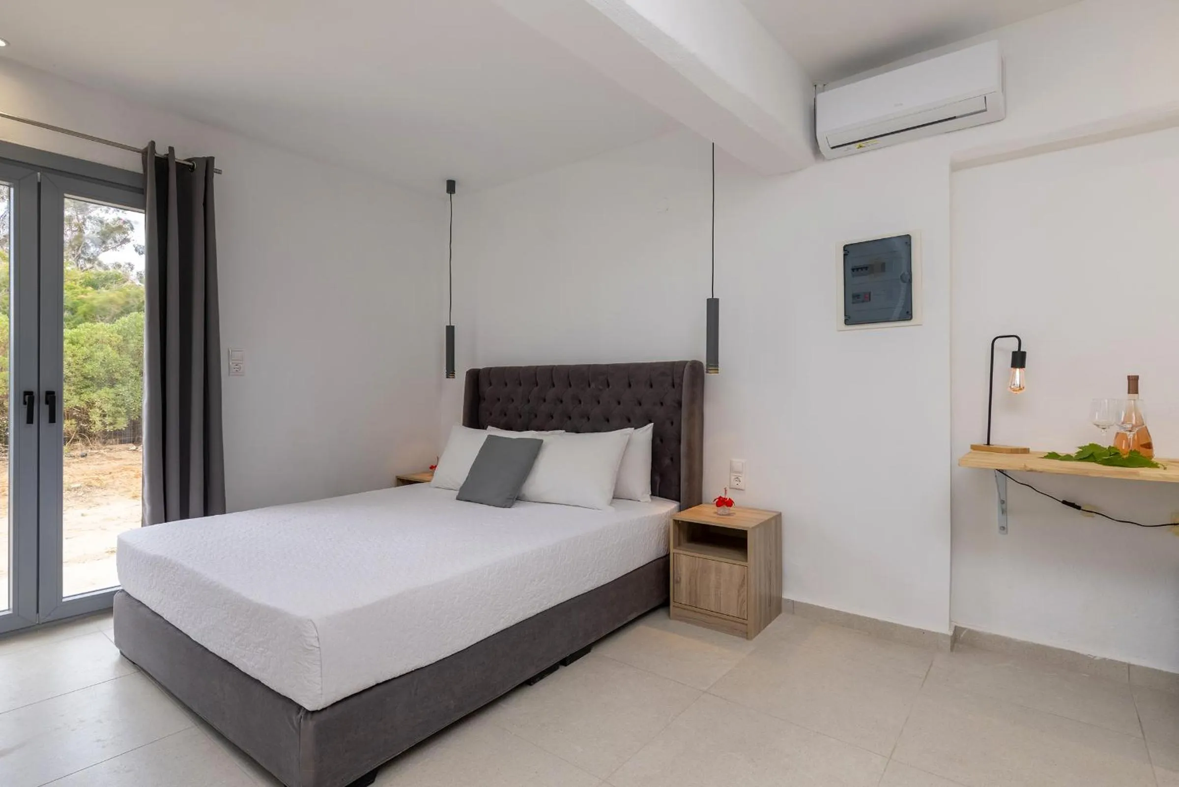 Bed in Chrysonisos Suites with Sunset & Seaviews near Kini