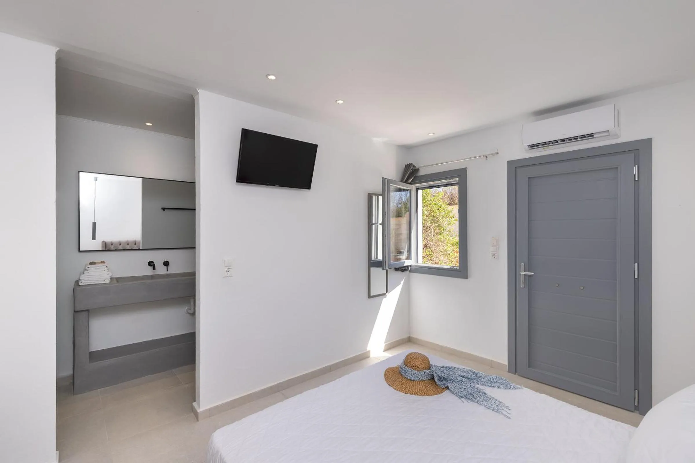 Bed in Chrysonisos Suites with Sunset & Seaviews near Kini