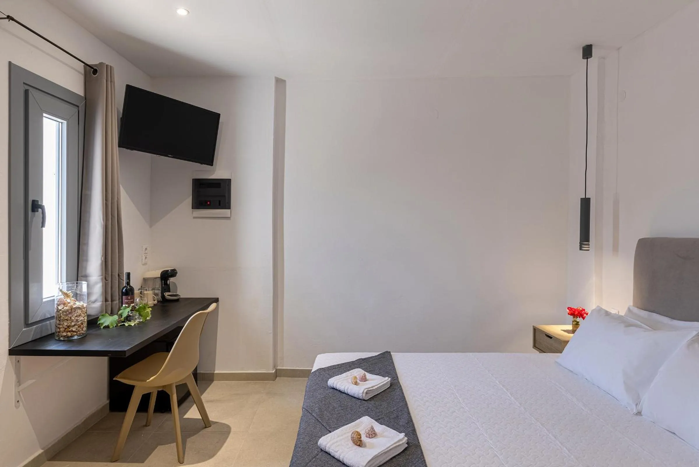 Bed in Chrysonisos Suites with Sunset & Seaviews near Kini