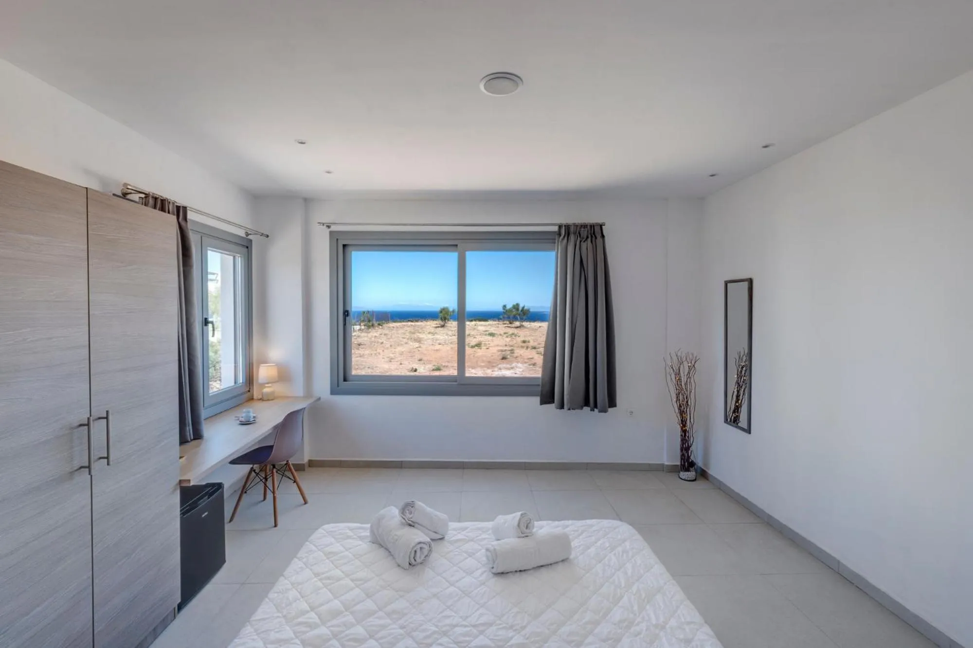 Bed in Chrysonisos Suites with Sunset & Seaviews near Kini