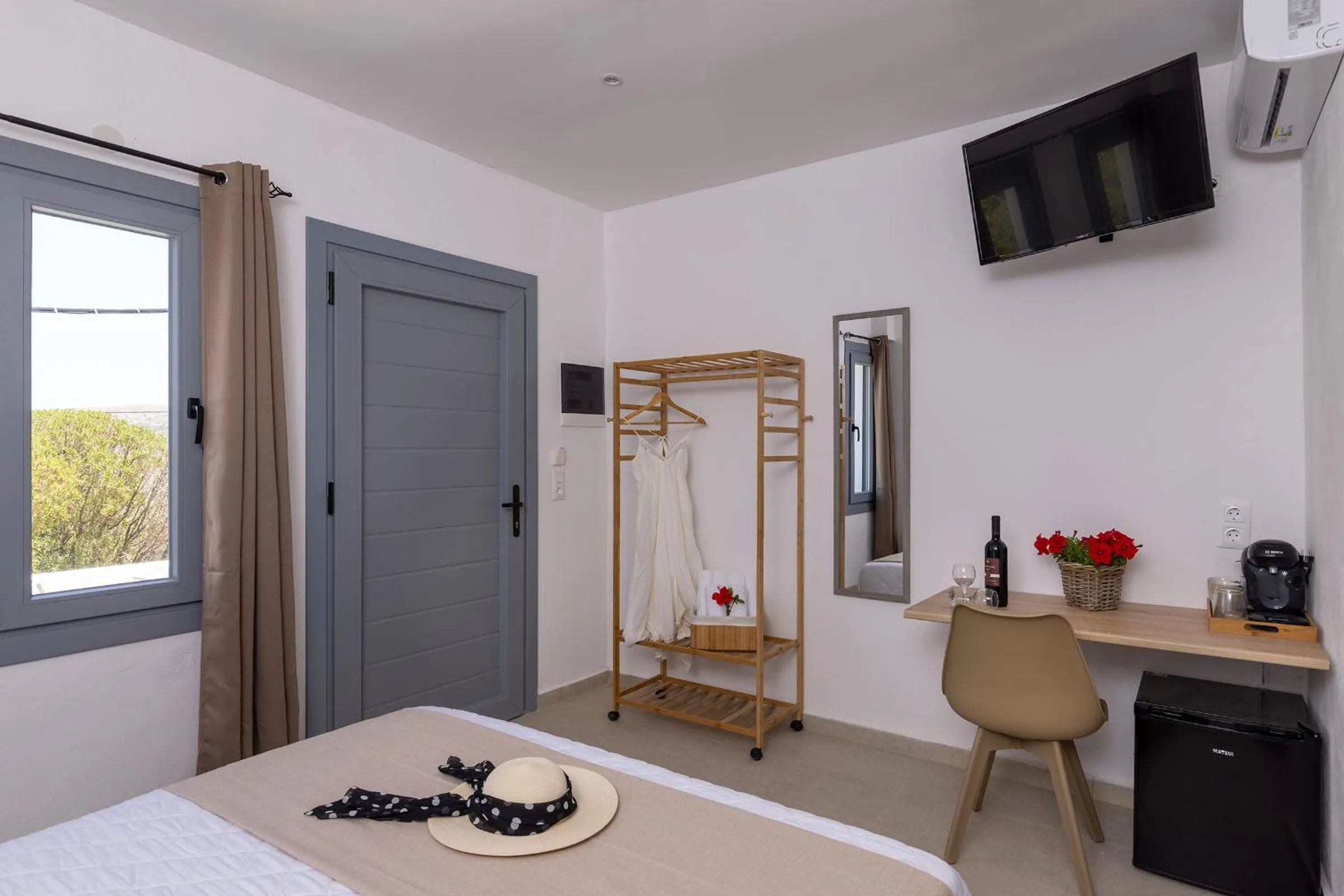 Photo of the whole room, Bed in Chrysonisos Suites with Sunset & Seaviews near Kini