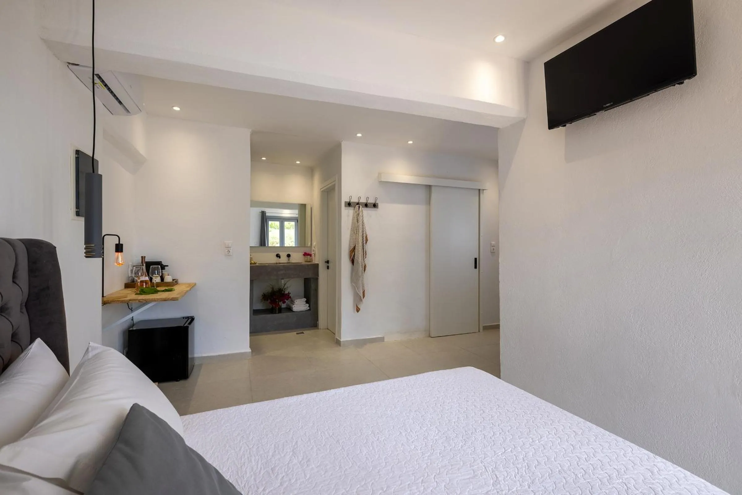 Bed in Chrysonisos Suites with Sunset & Seaviews near Kini