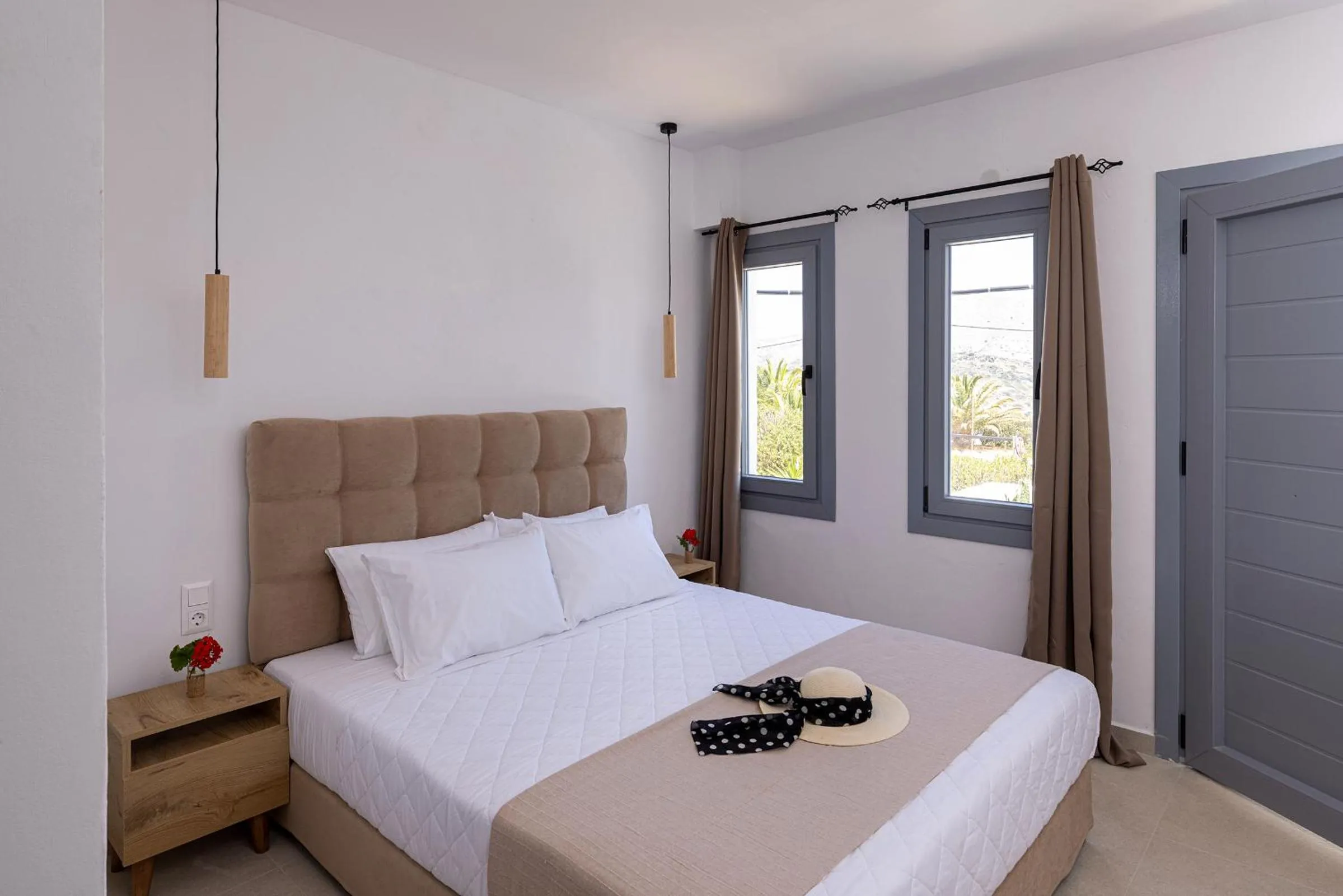 Bed in Chrysonisos Suites with Sunset & Seaviews near Kini