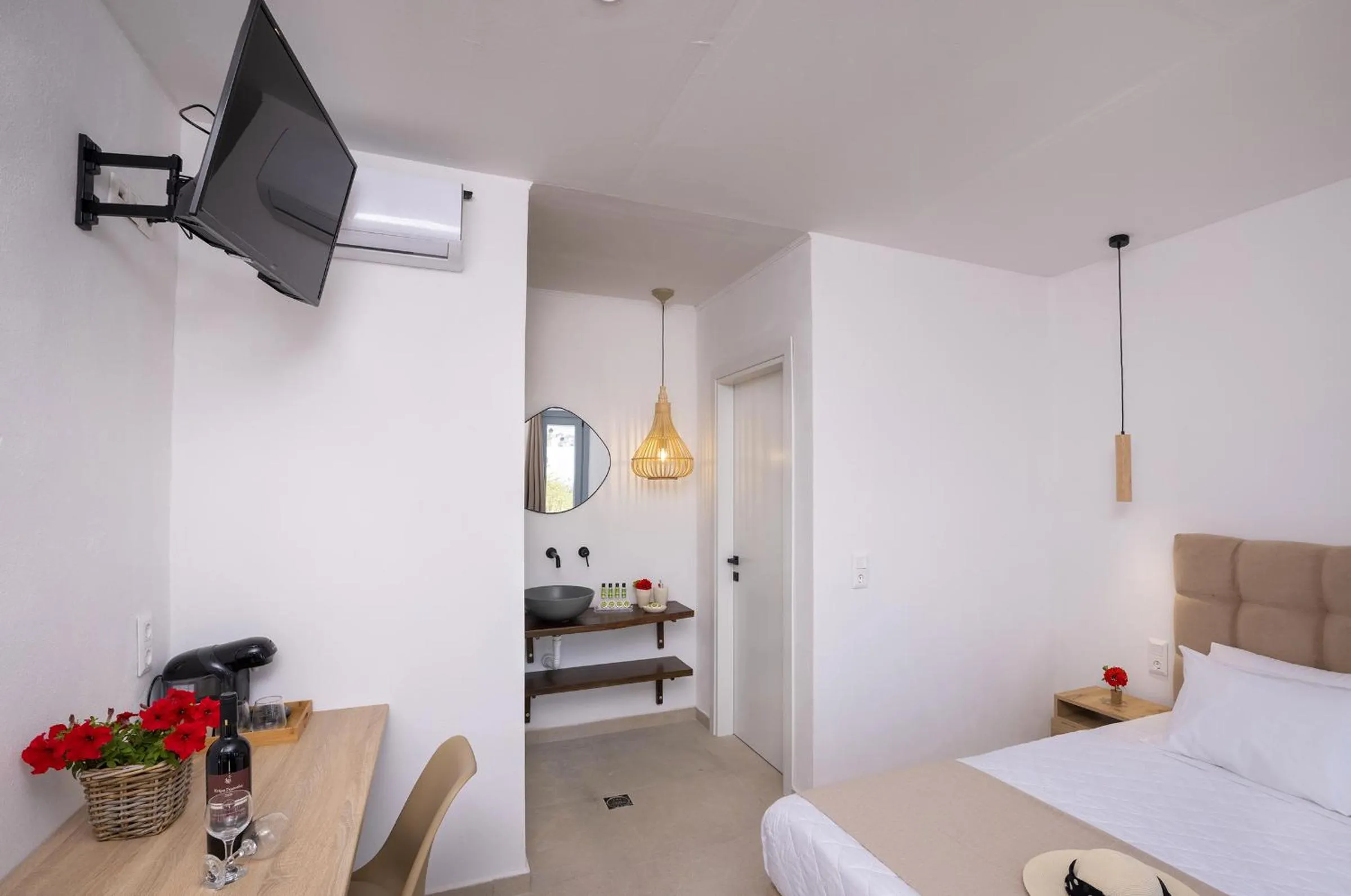 Bed in Chrysonisos Suites with Sunset & Seaviews near Kini