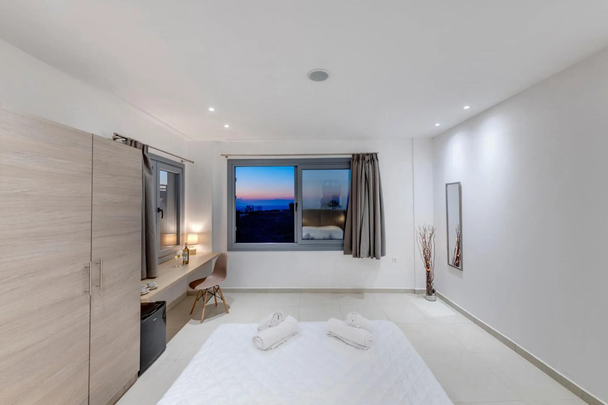 Bed in Chrysonisos Suites with Sunset & Seaviews near Kini