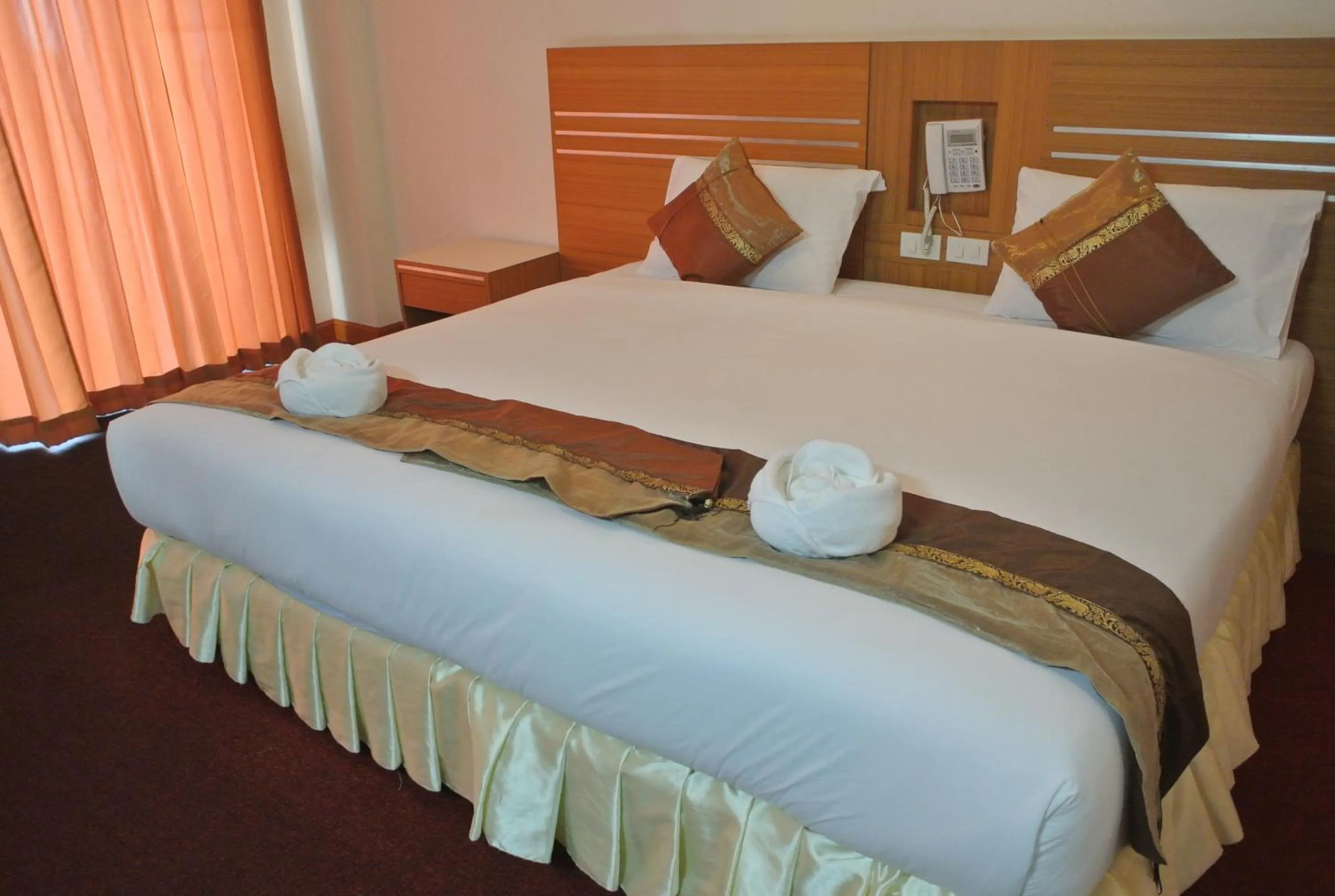 Bed in Chaikana Thani Hotel