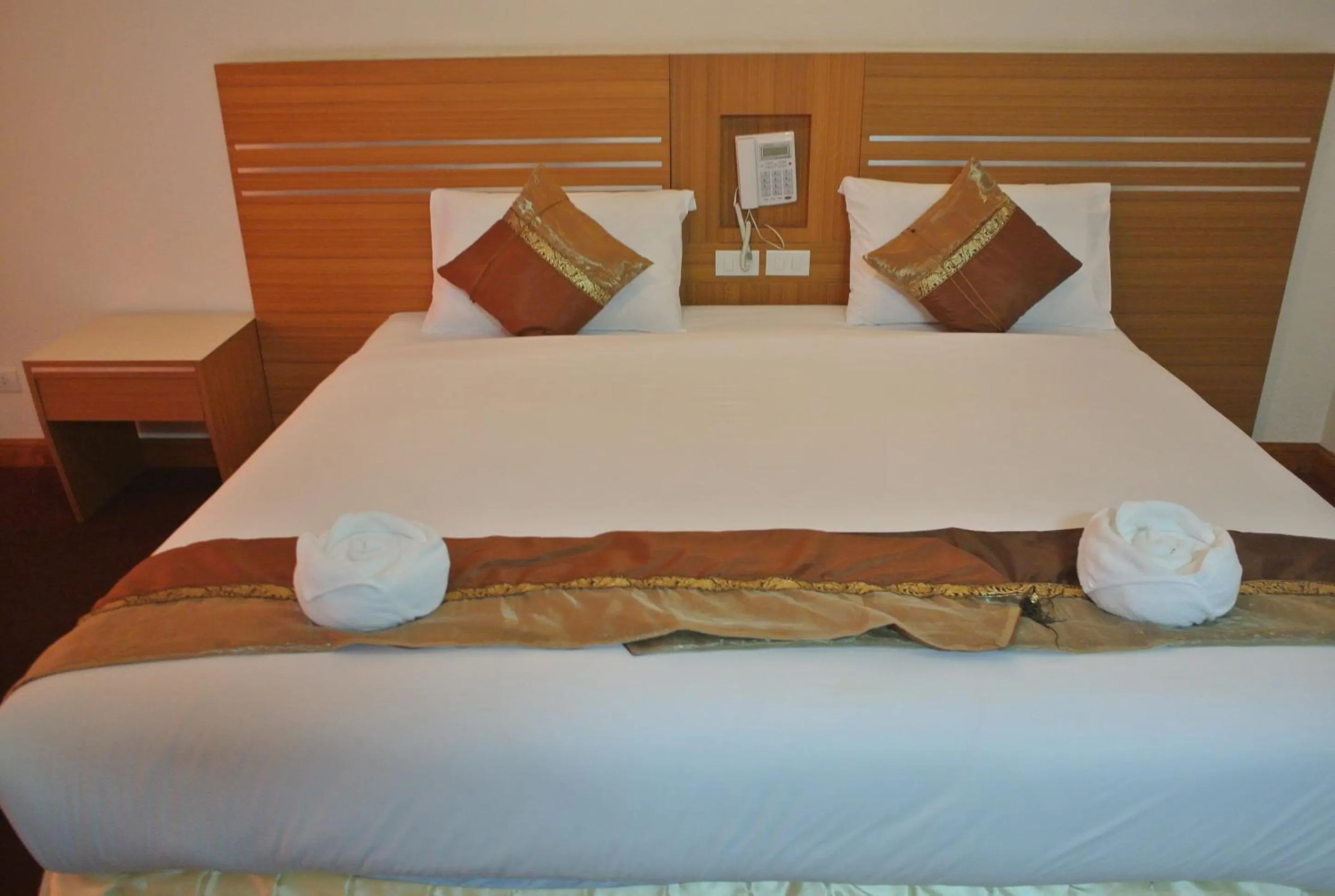 Bed in Chaikana Thani Hotel