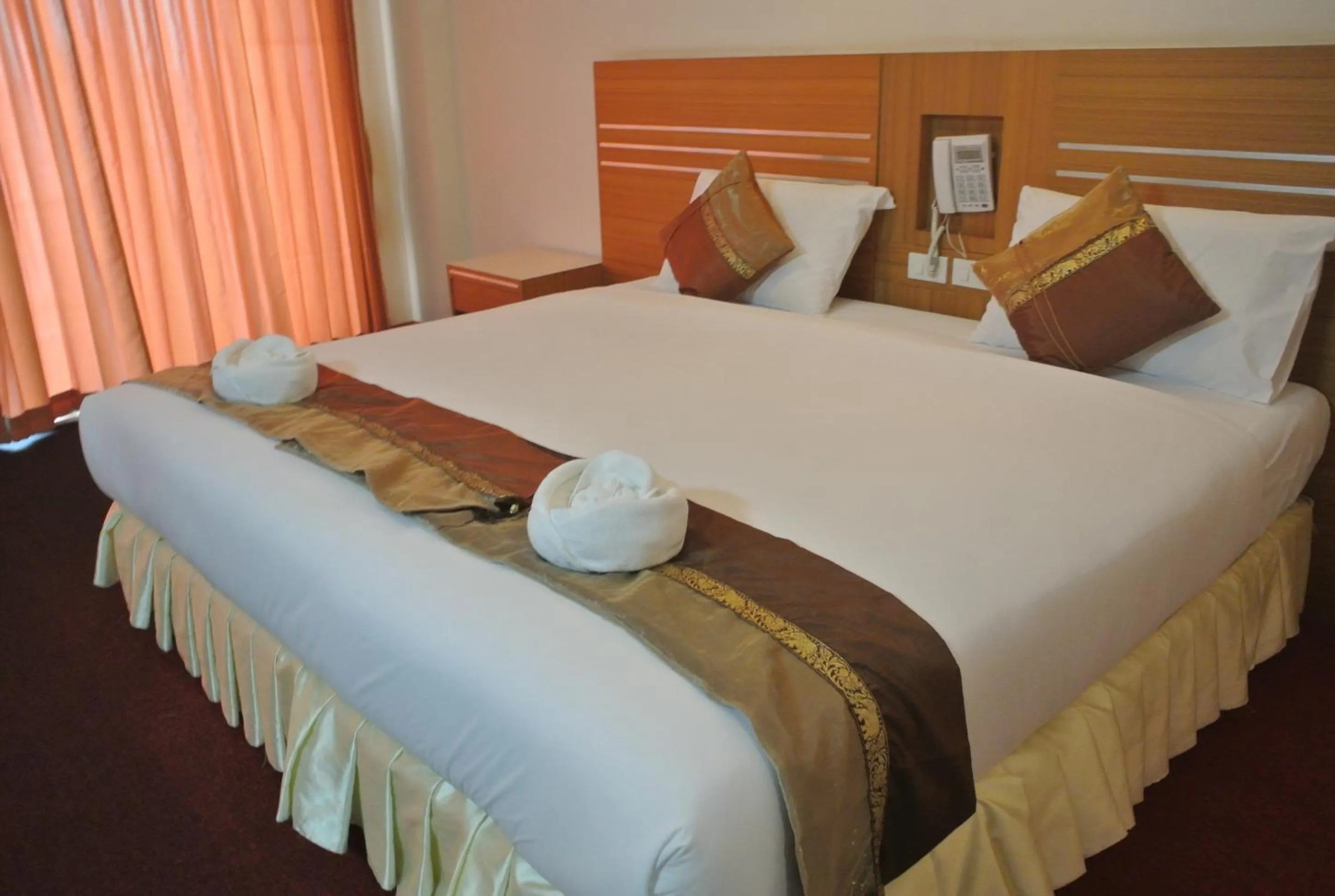 Bed in Chaikana Thani Hotel