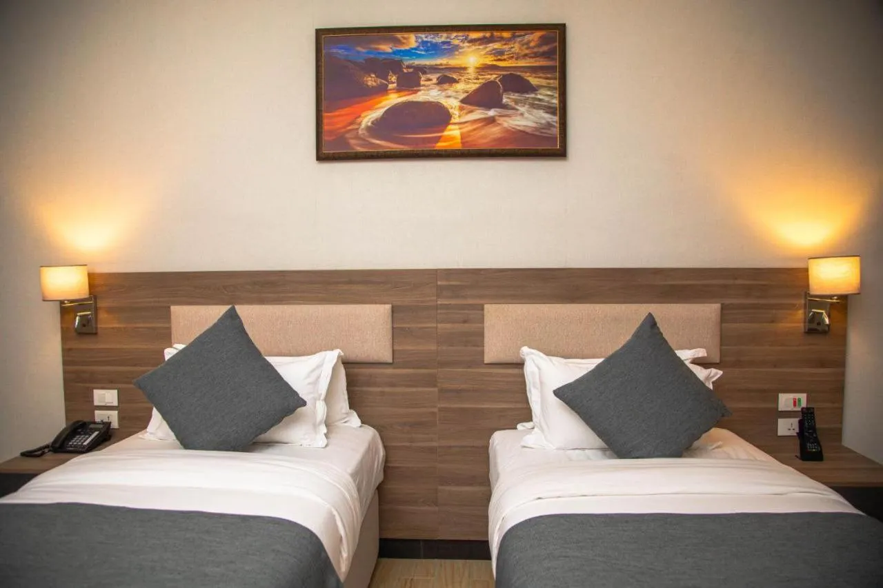 Bed in Triple E Hotel and Spa