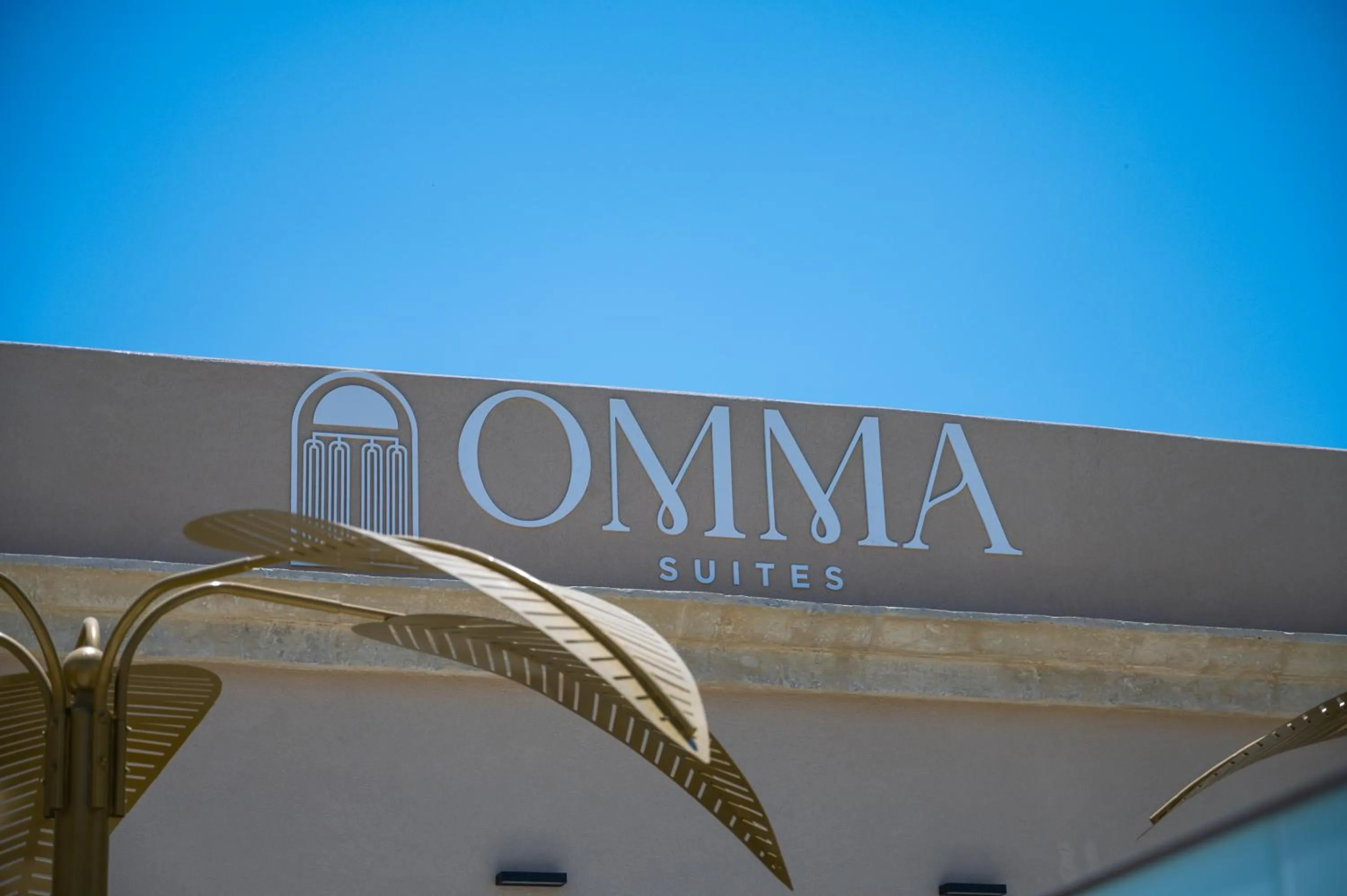 Property logo or sign in Omma Suites