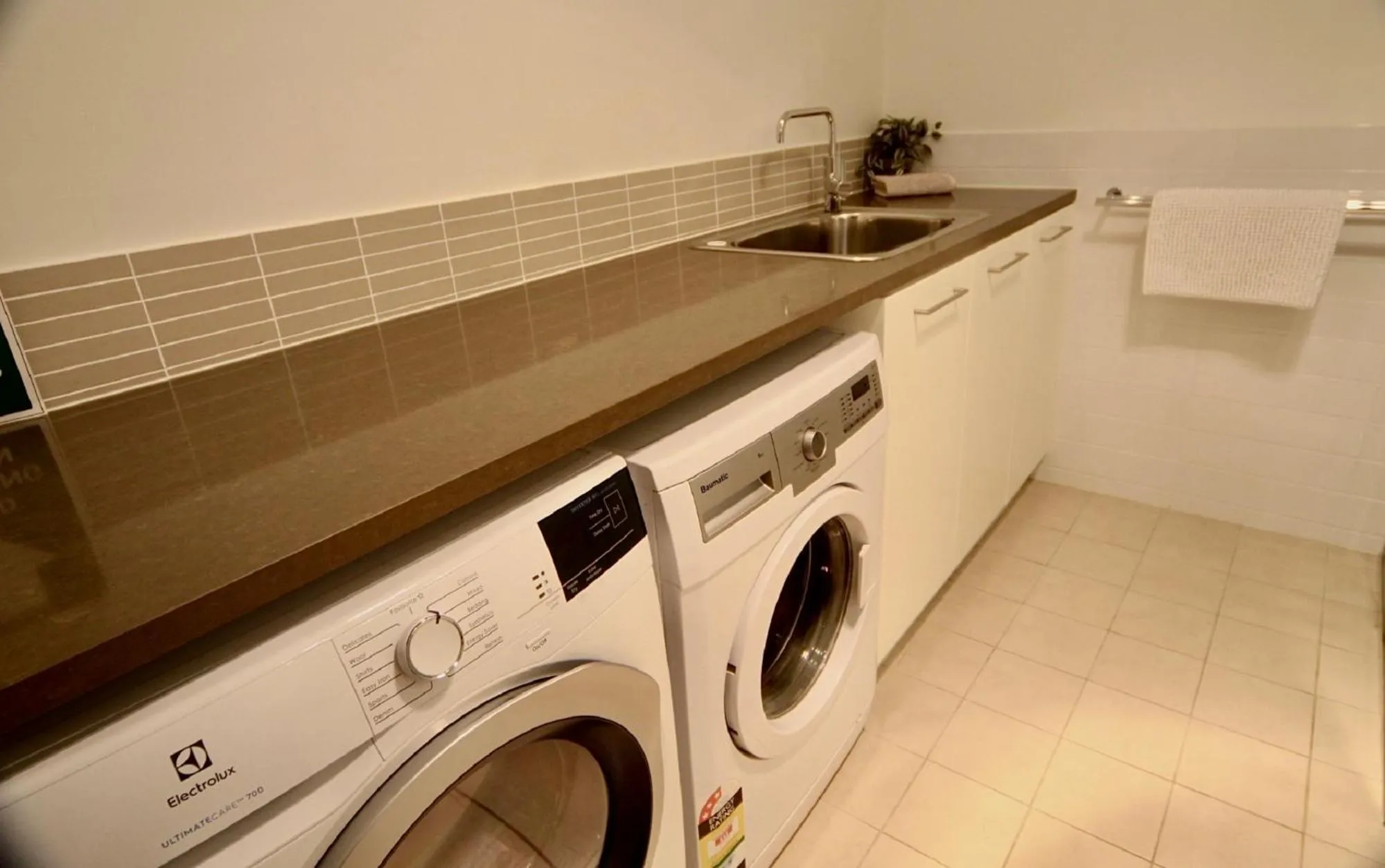 washing machine in Breeze Beachfront Apartment