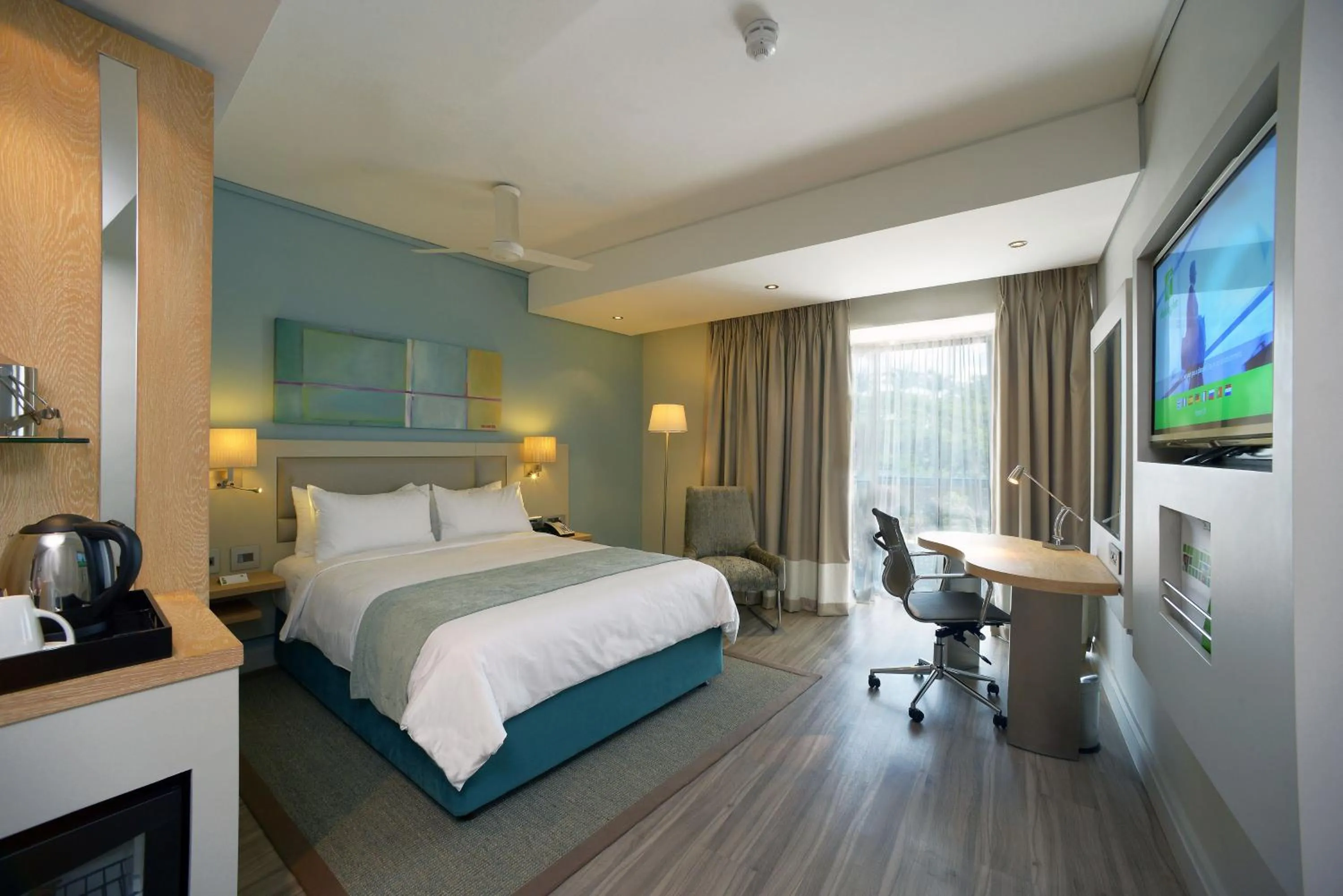 Photo of the whole room, Bed in Holiday Inn Mauritius Mon Trésor by IHG