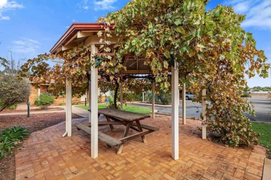 Patio in Adorable-secure 3 bedroom holiday home with Pool around the corner from The Miners Rest.