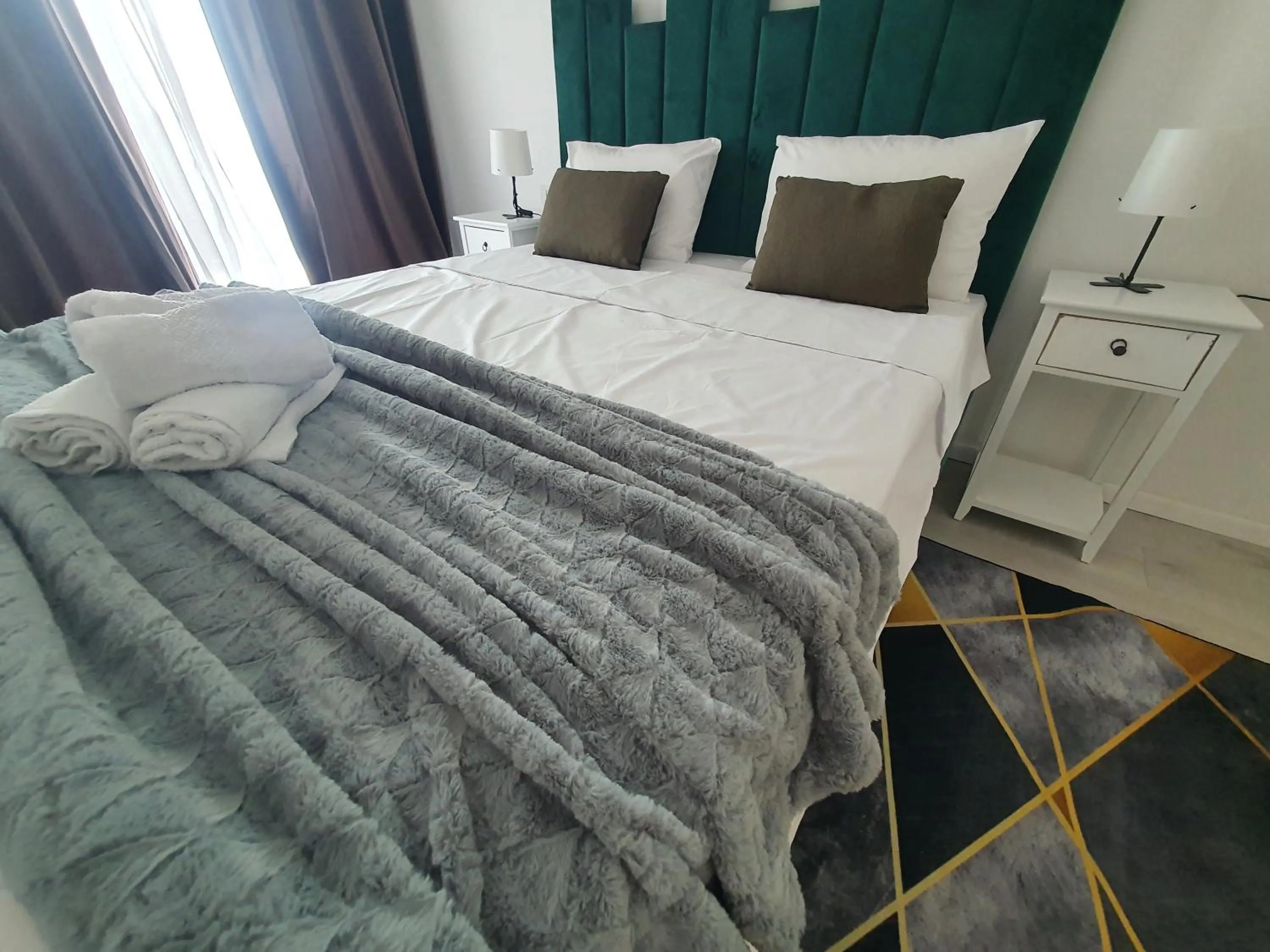 Bed in Grey Residence Apartments