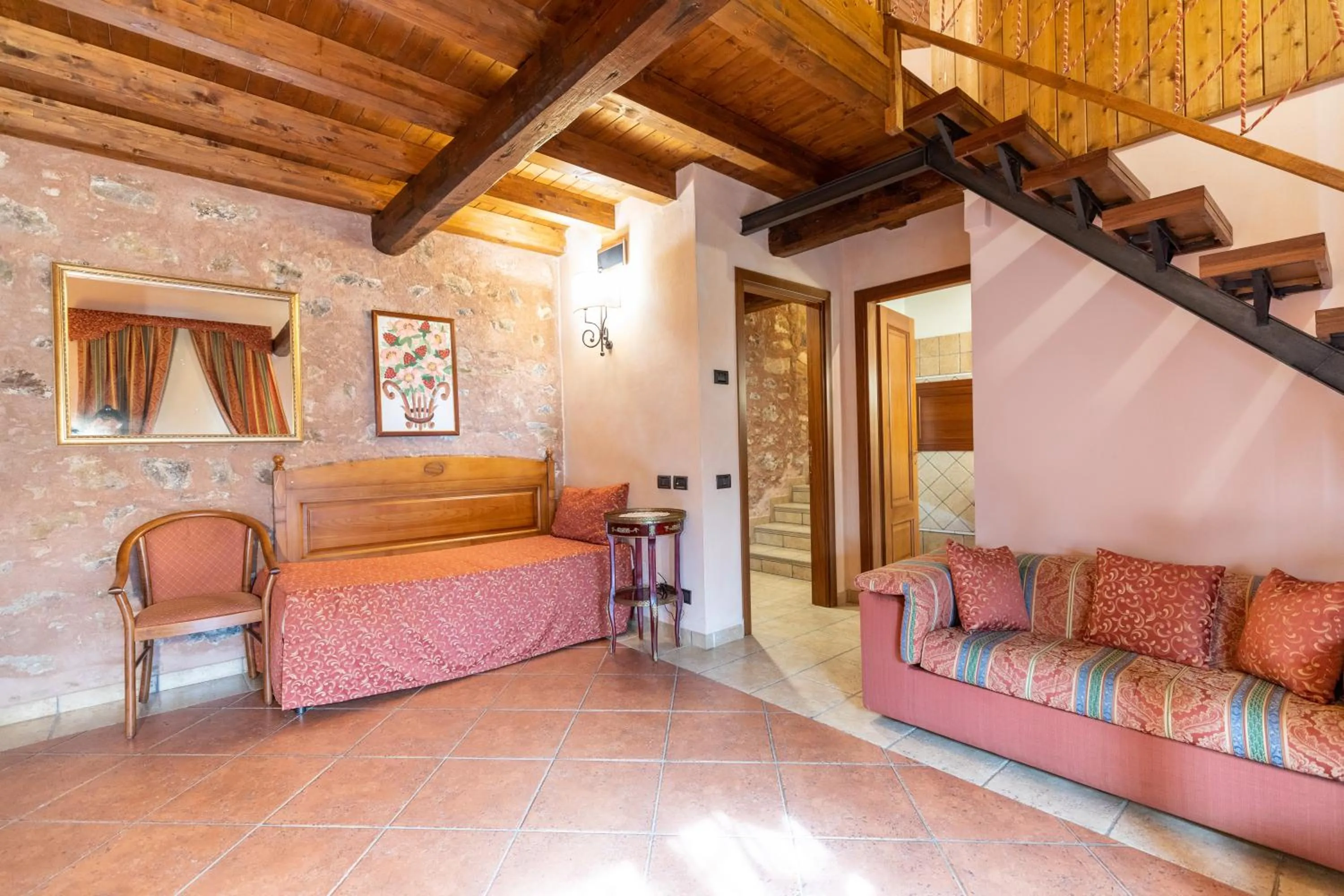 Seating area, Bed in Relais Abbazia Santa Anastasia Resort & Winery