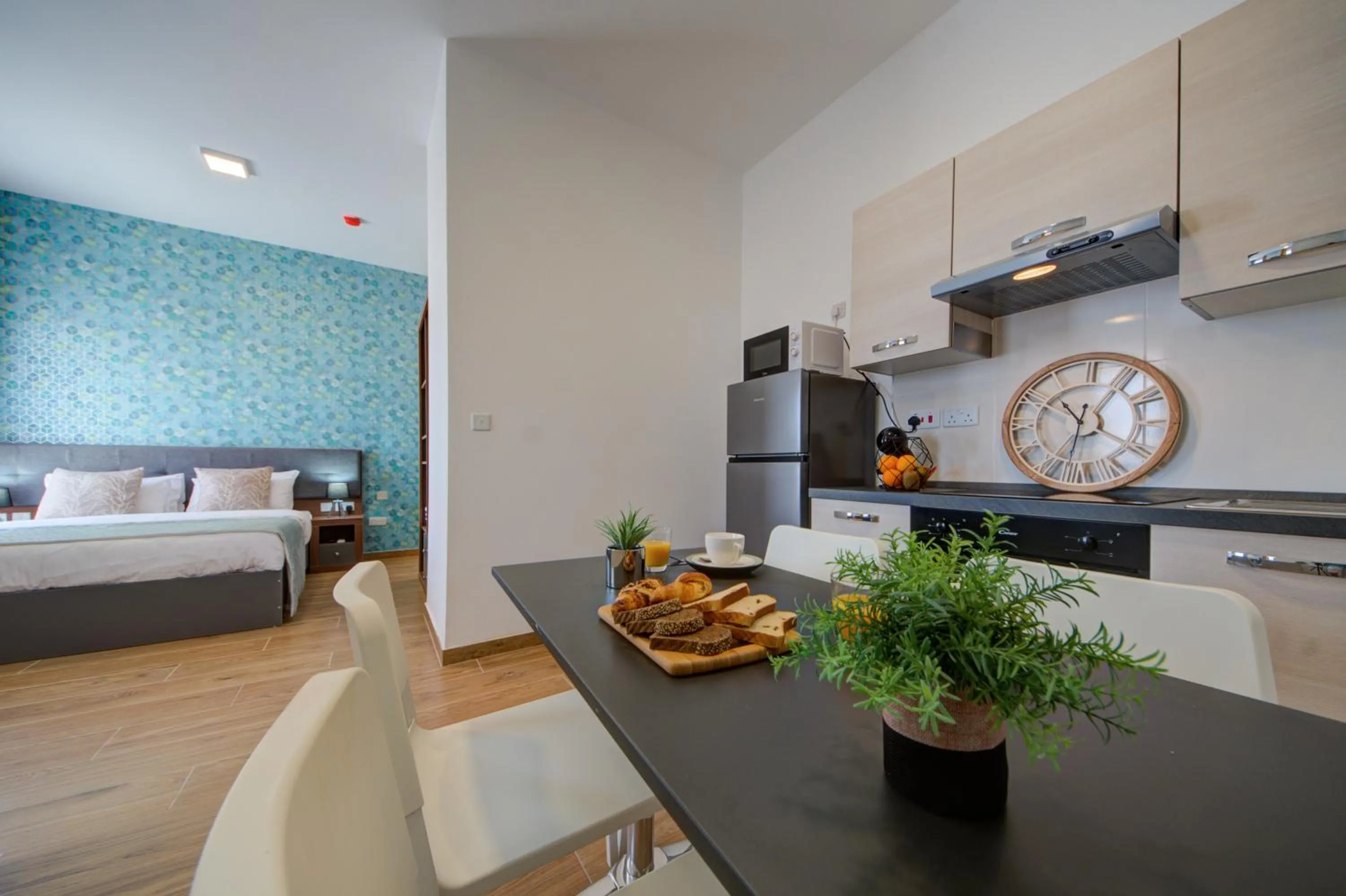 Kitchen or kitchenette, Bed in Marina Suites & apartments - Self catering - by Tritoni hotels