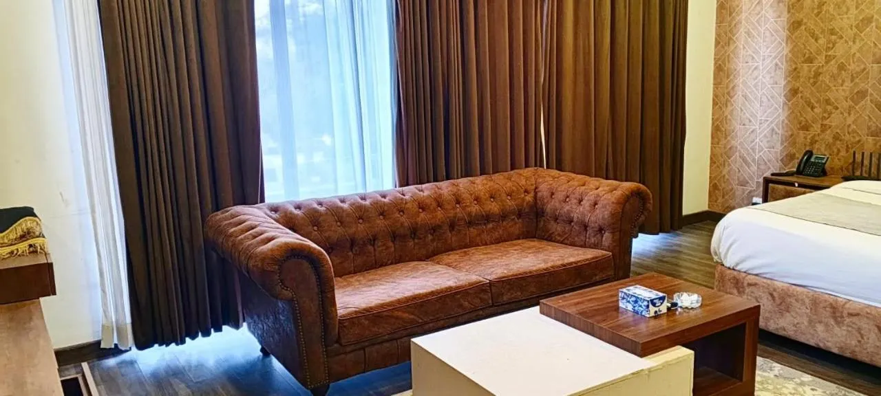 Seating area, Bed in OXVUE Boutique Hotel