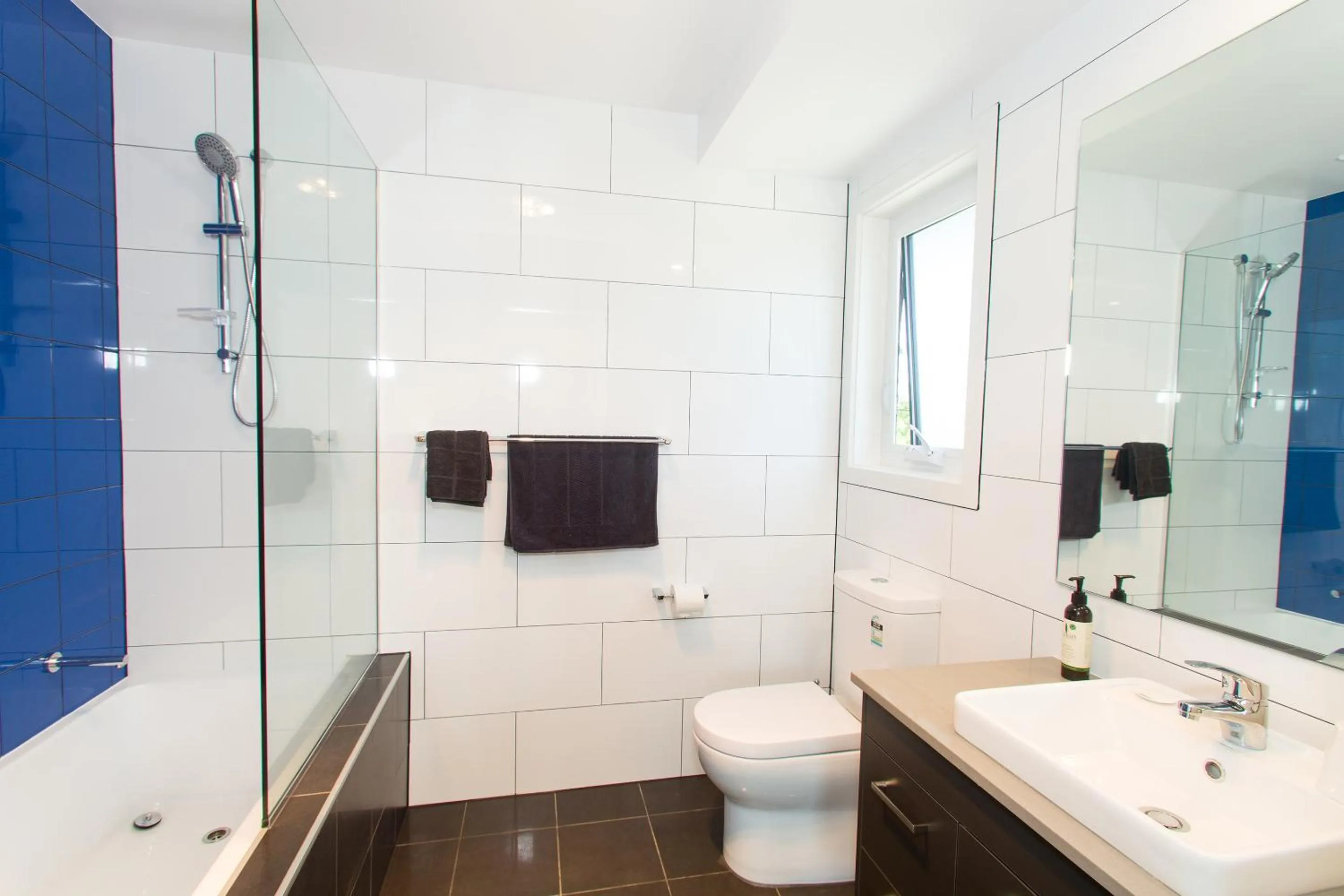 Toilet, Bathroom in One of a Kind Apartments