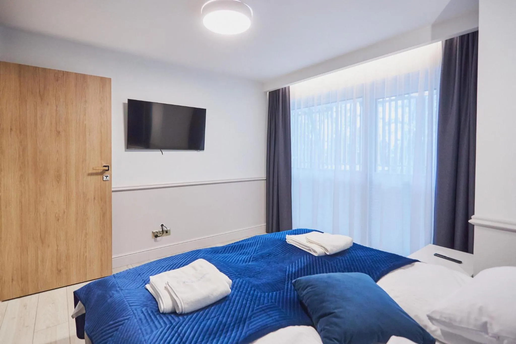 Bed in Timber Apartments by Baltic Home