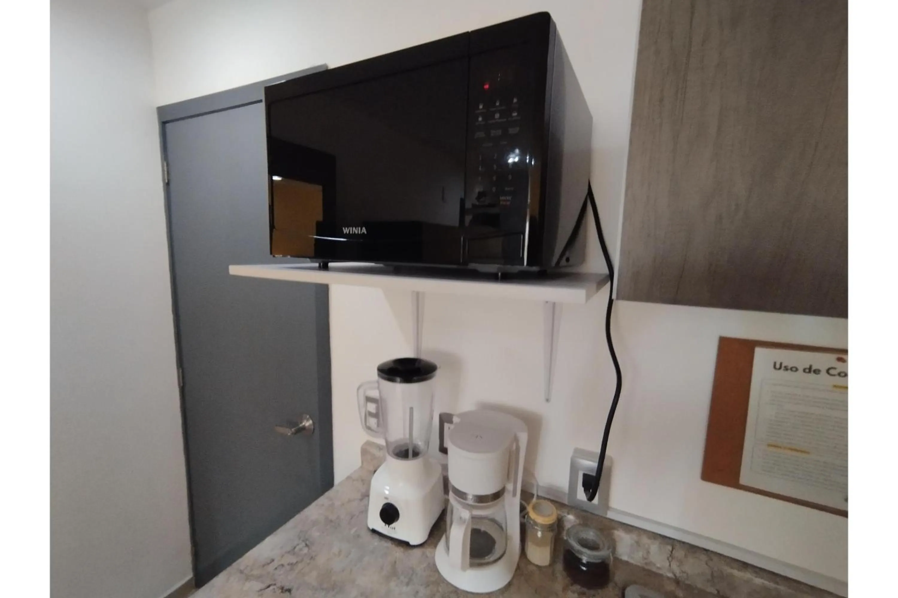 Kitchen or kitchenette in Capital O Tu Estancia