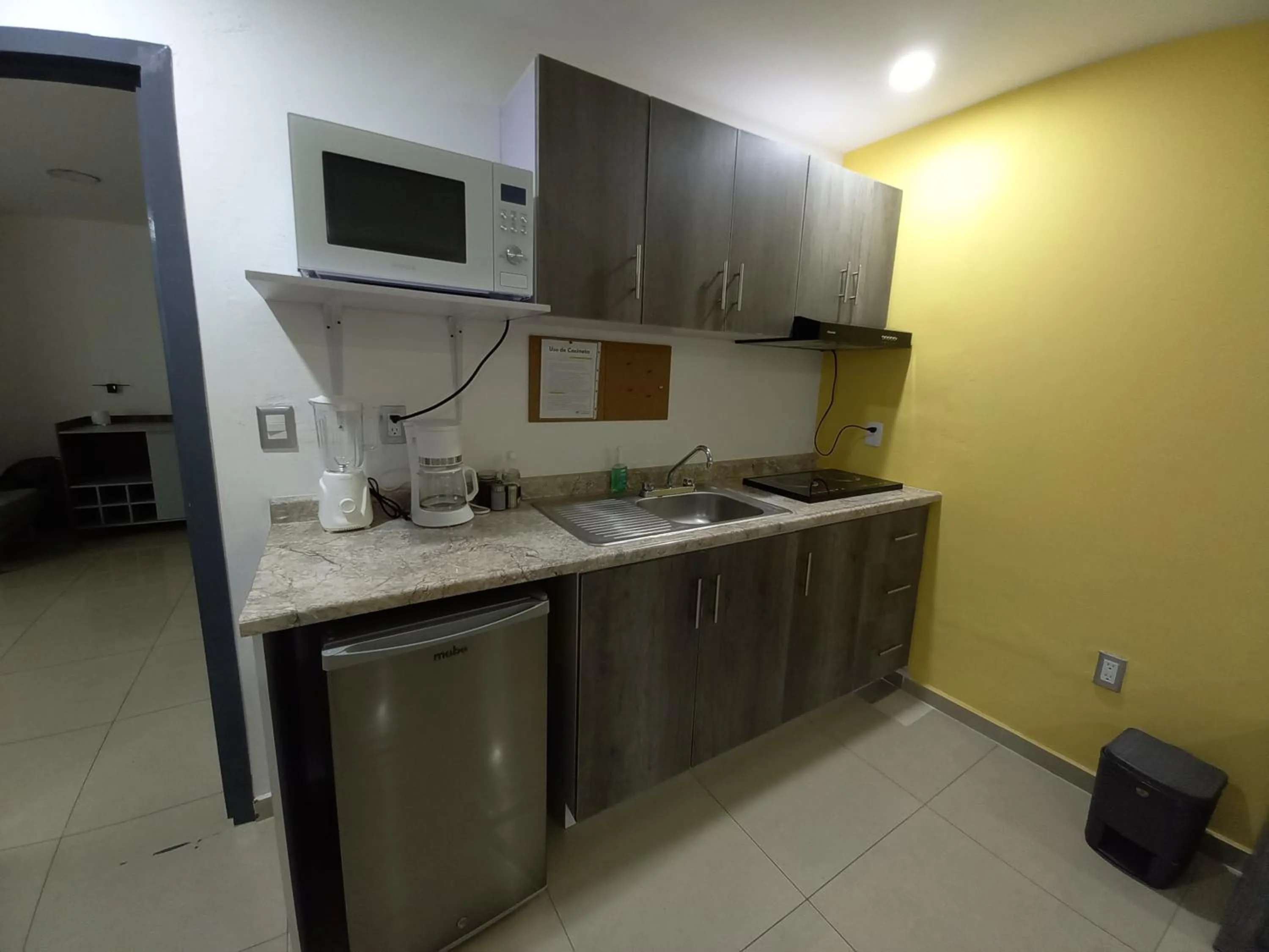 Kitchen or kitchenette in Capital O Tu Estancia