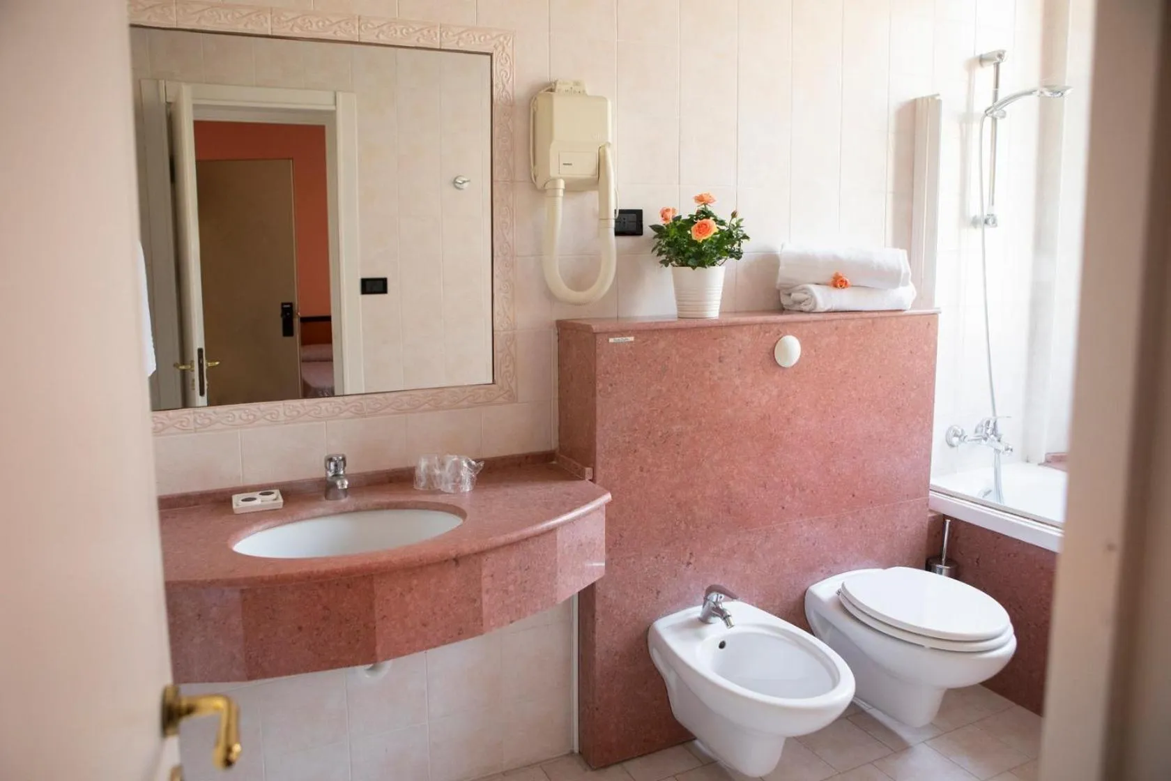 Toilet in Hotel Milano Pool & Garden