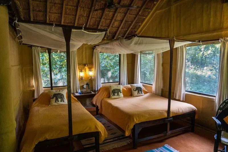 Bed in Tiger Tops Karnali Lodge