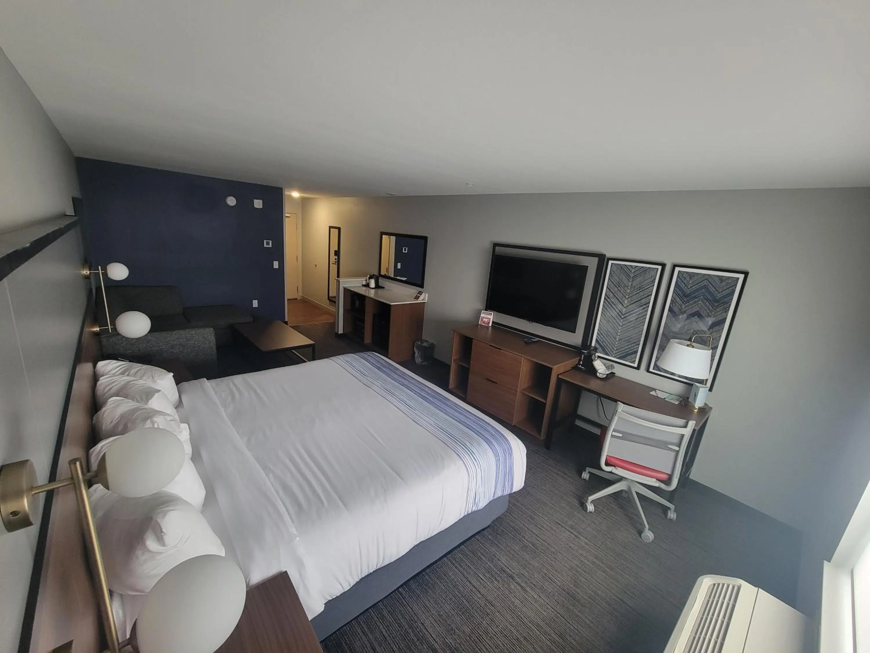 Seating area, Bed in AmericInn by Wyndham International Falls