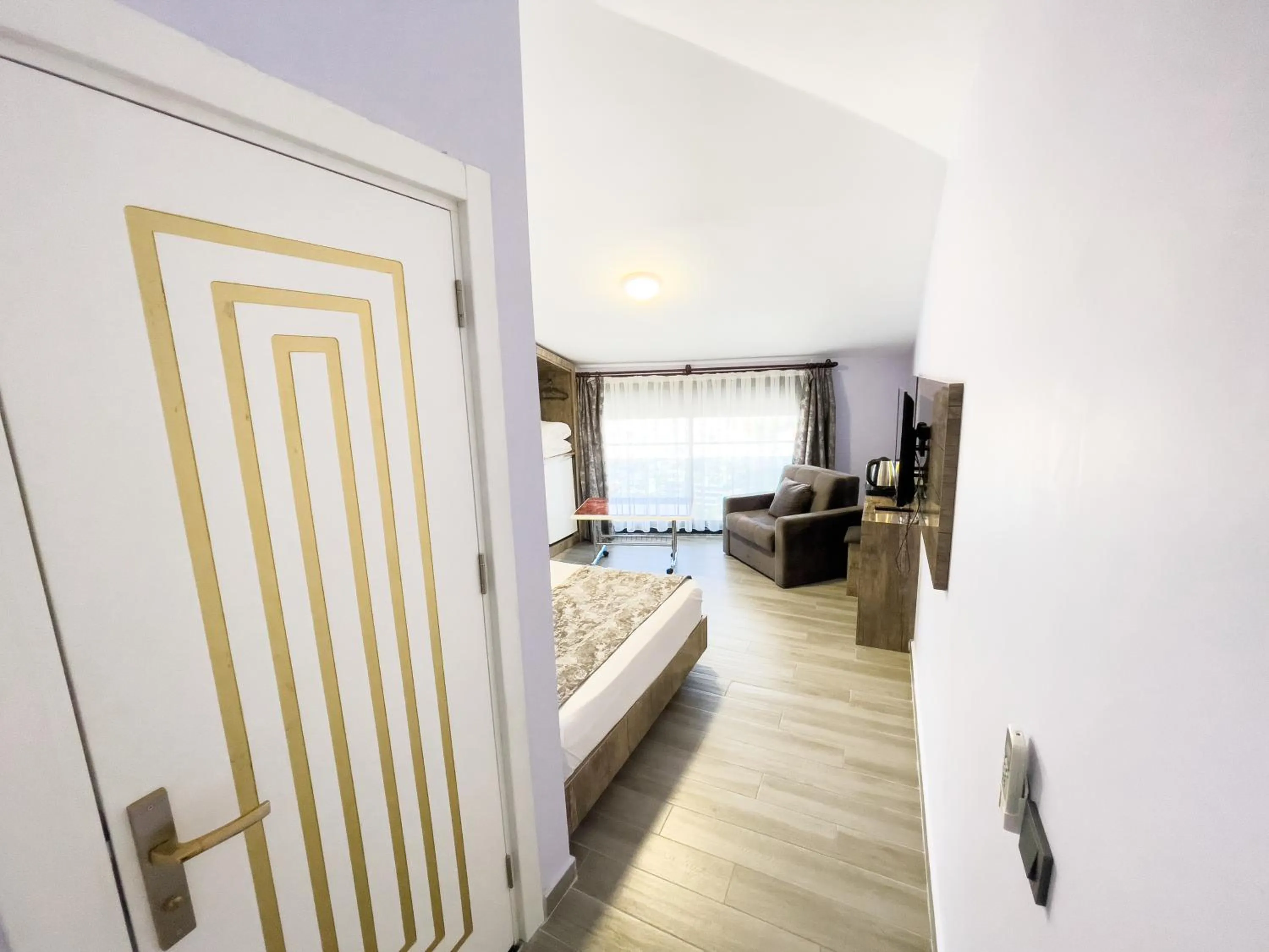 Photo of the whole room, Bed in Castle Light Boutique