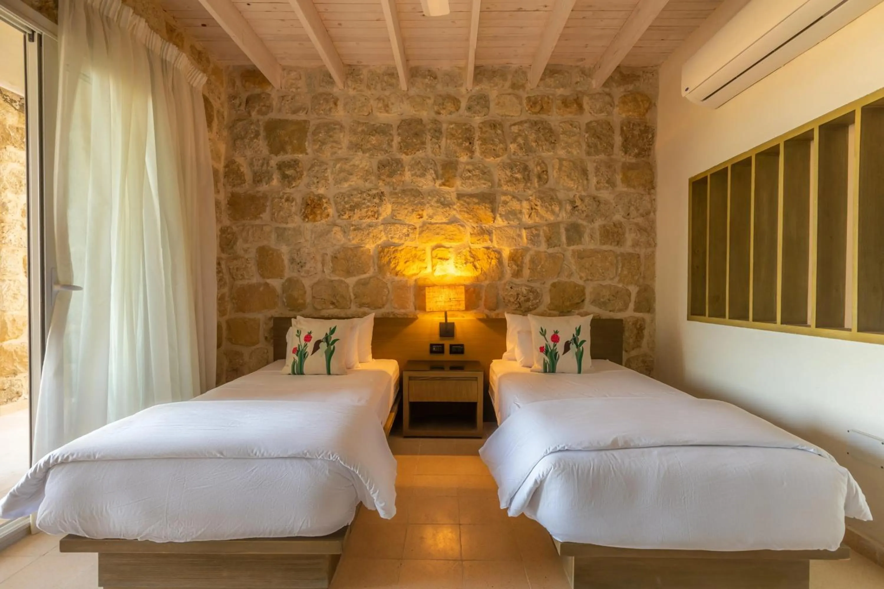 Bed in Wadi Sabarah Lodge