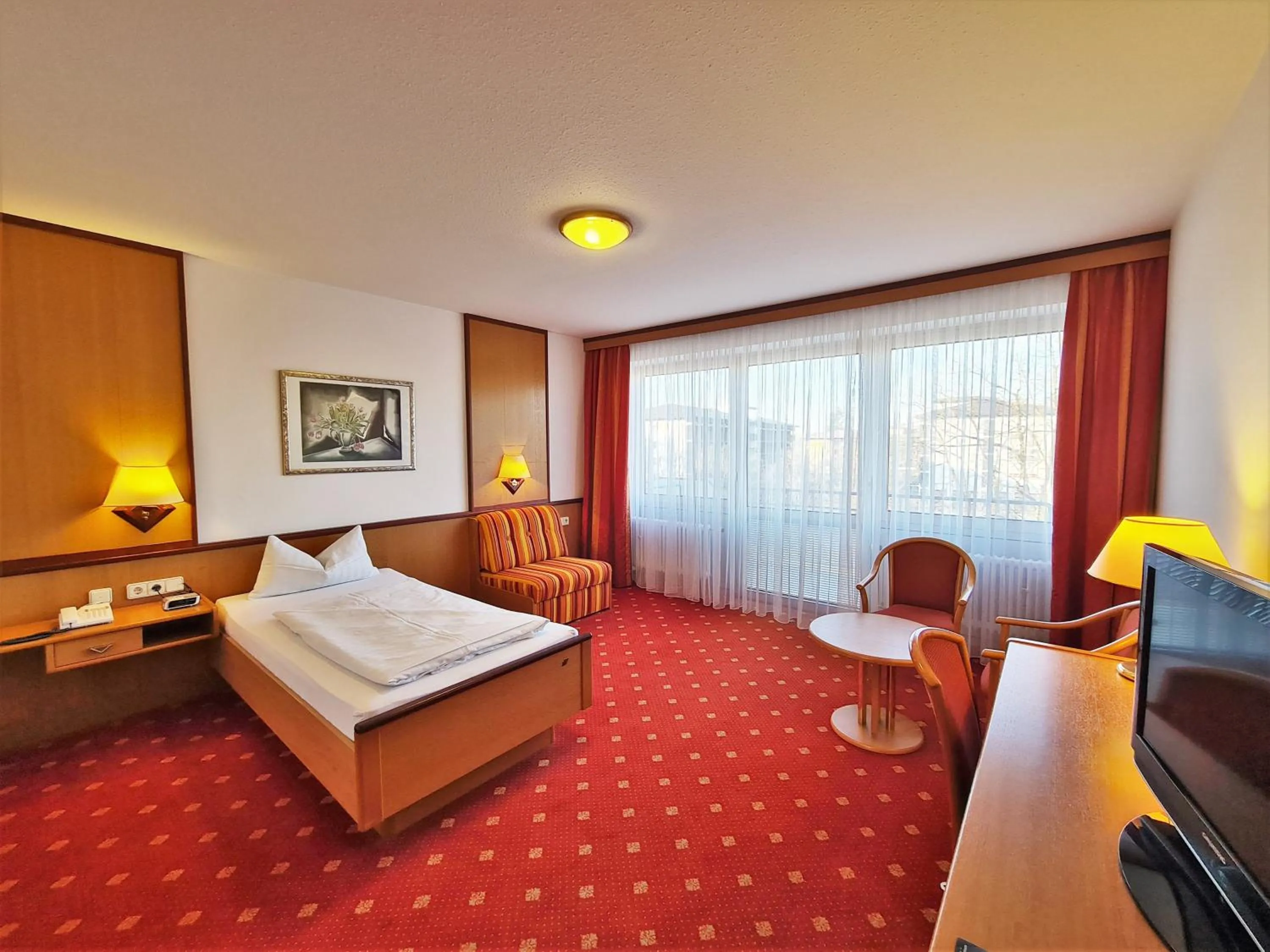 Photo of the whole room, Bed in Thermenhotel Tannenhof - Ihr Wohlfühl-Hotel