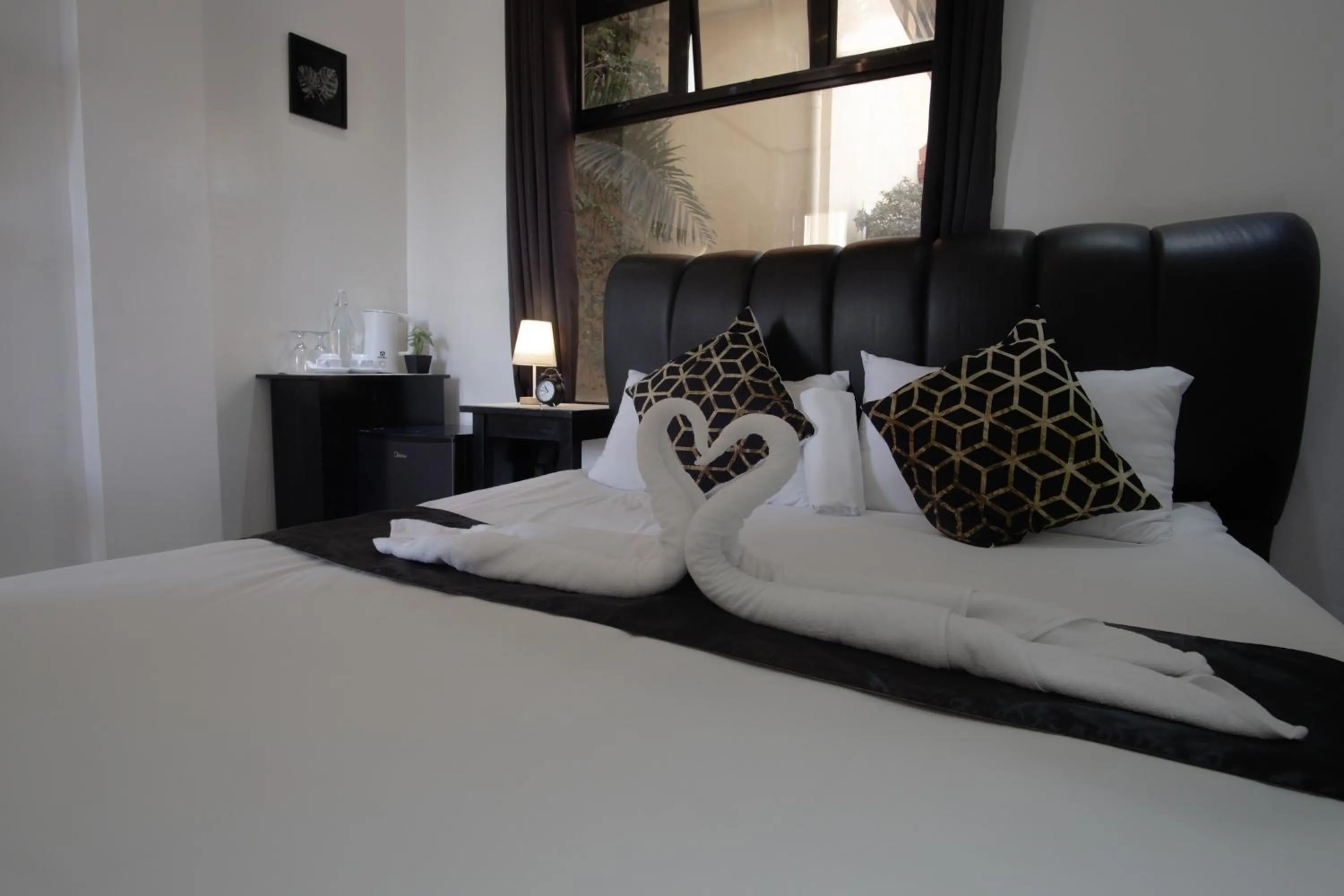 Bed in The Palms Resort & Bar