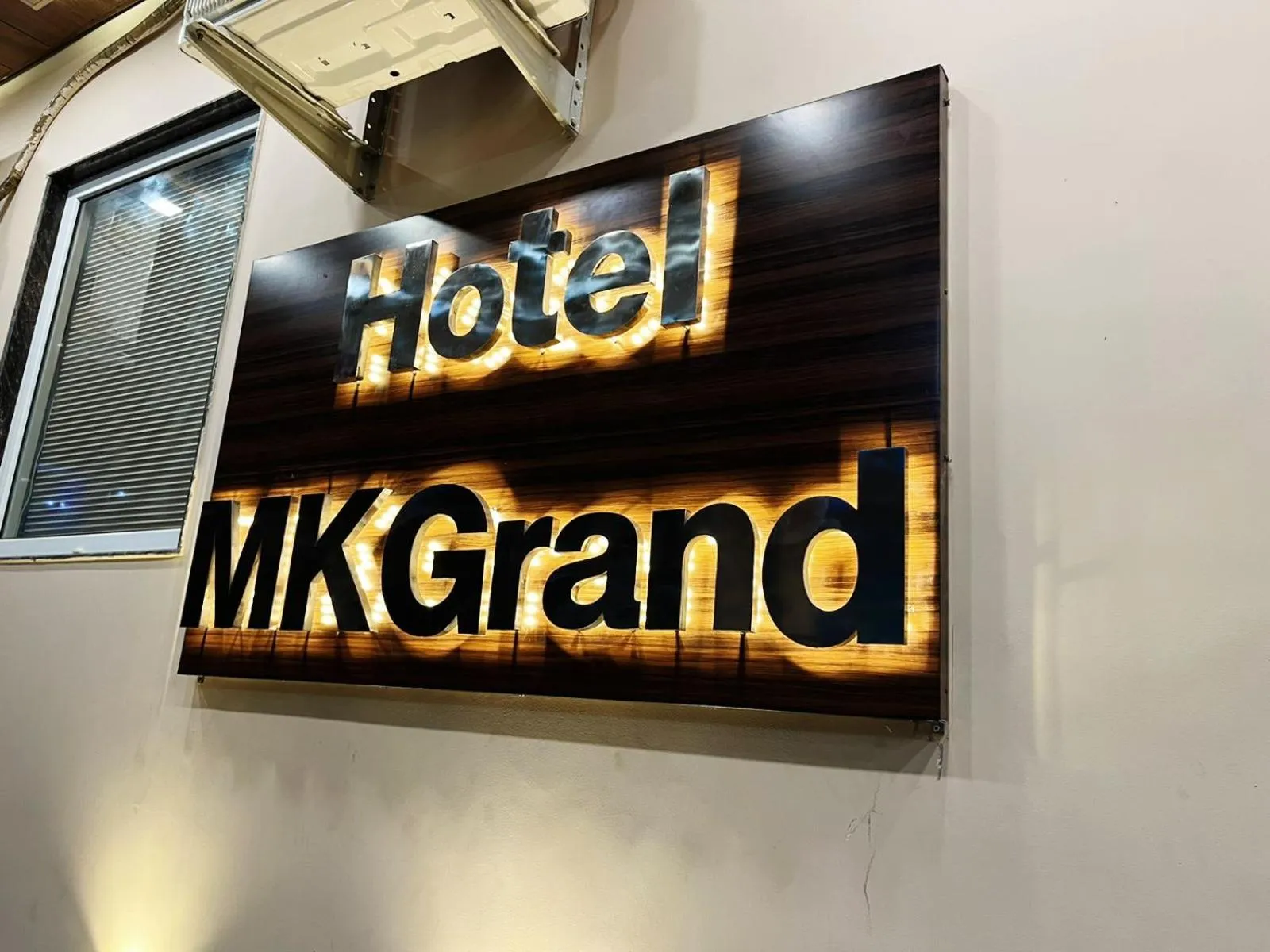Property logo or sign in Hotel MK Grand