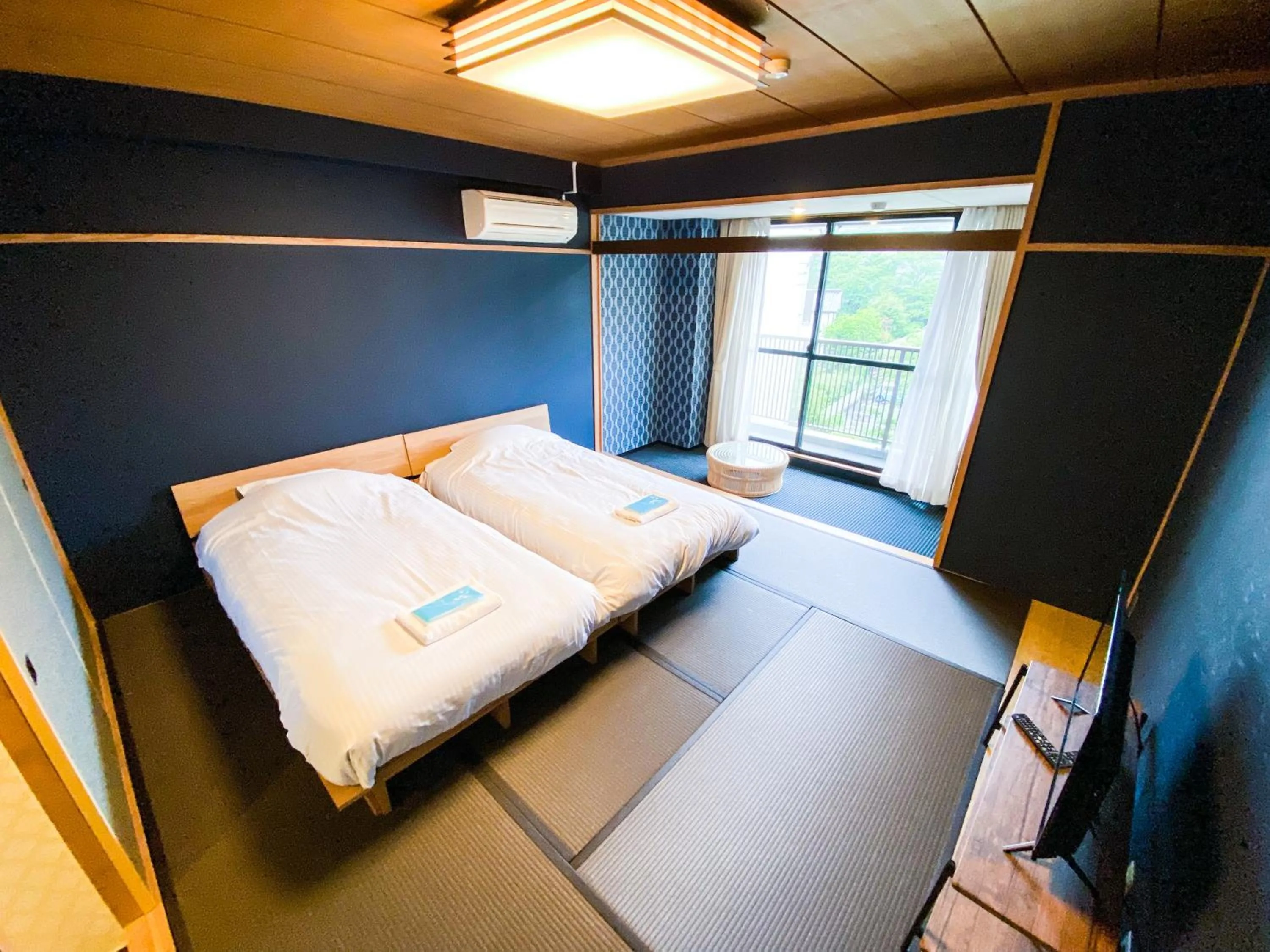 Photo of the whole room, Bed in ISOLA Izukogen
