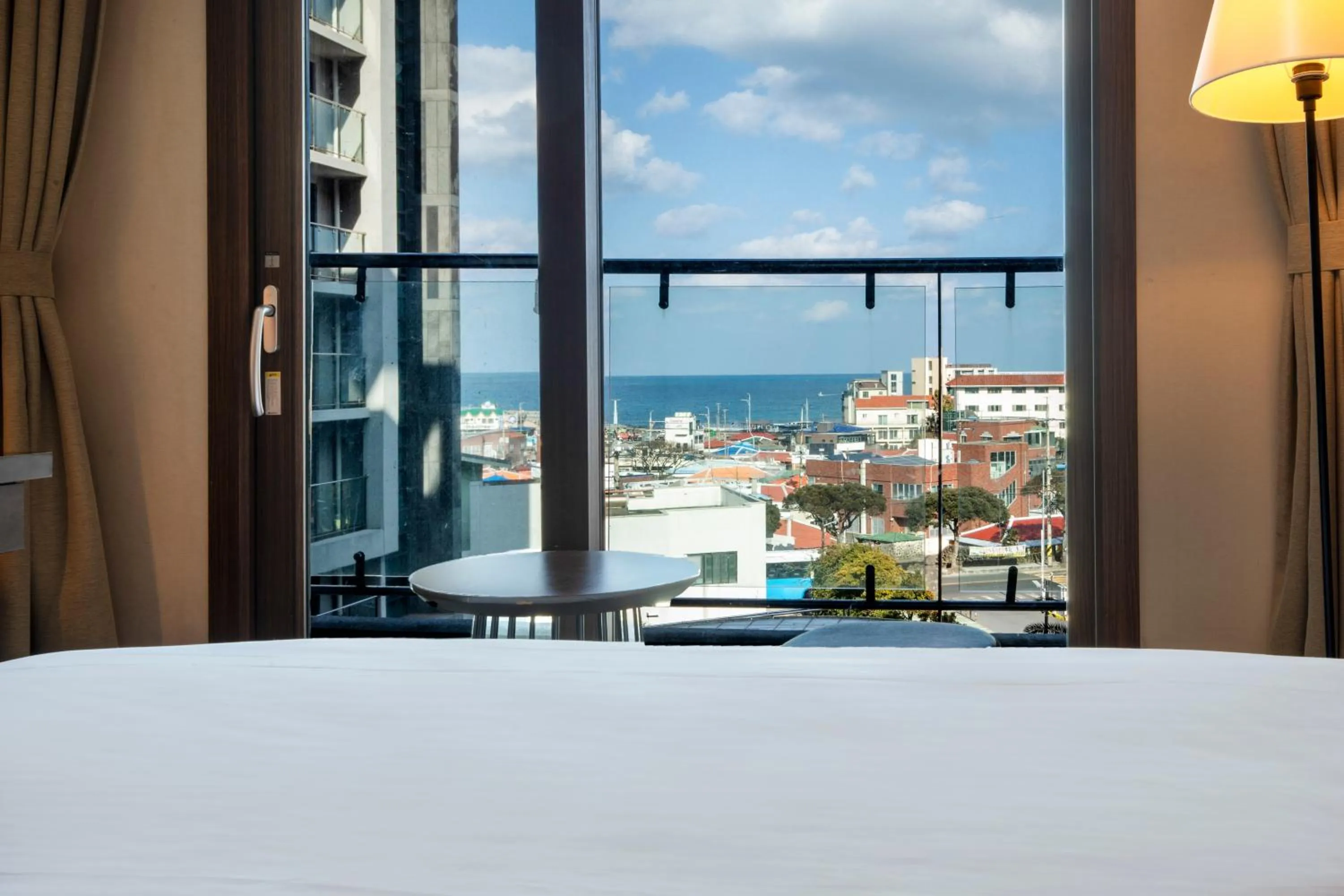 Bed in Ramada by Wyndham Jeju Hamdeok